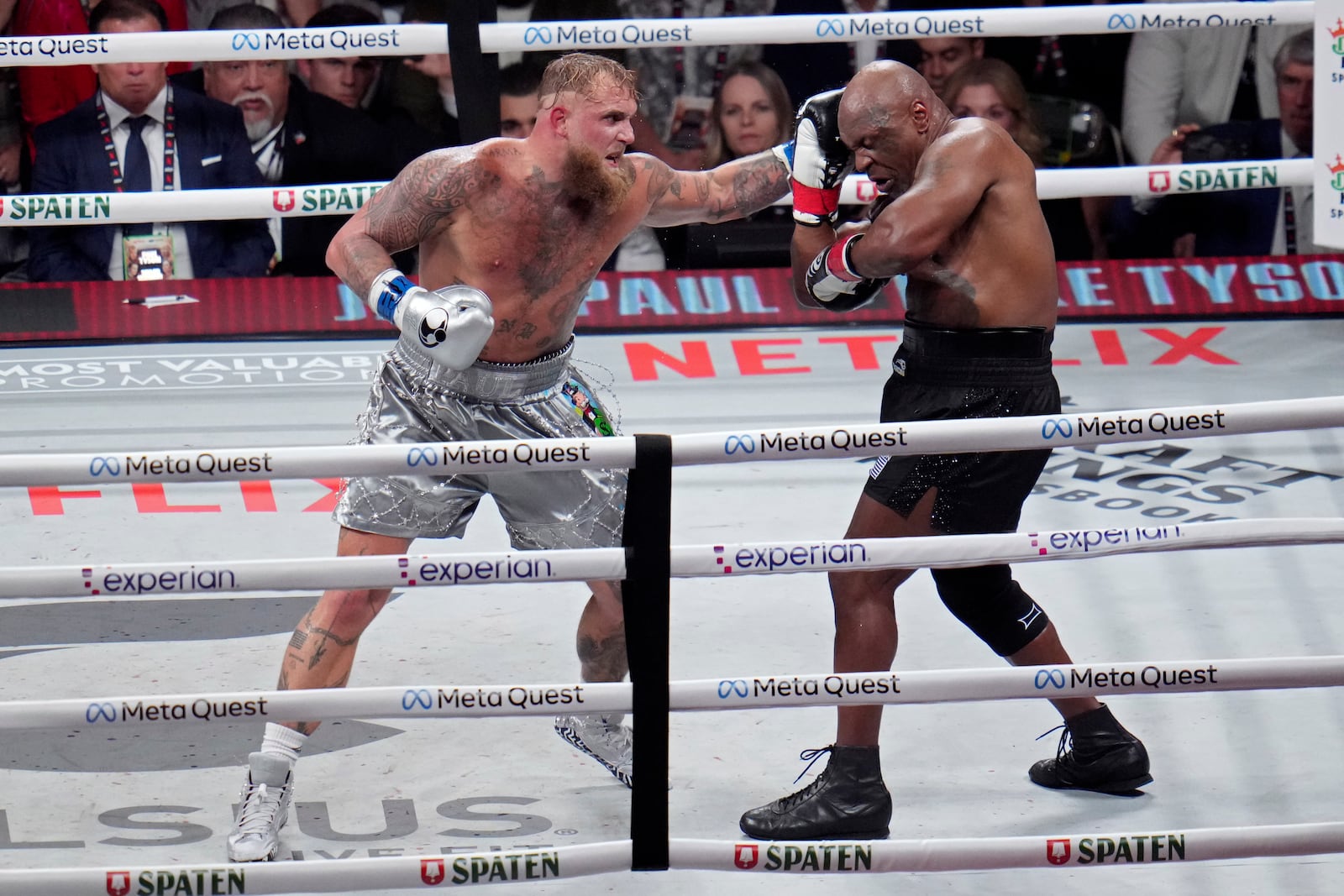 Jake Paul hits Mike Tyson during their heavyweight boxing match, Friday, Nov. 15, 2024, in Arlington, Texas. (AP Photo/Julio Cortez)