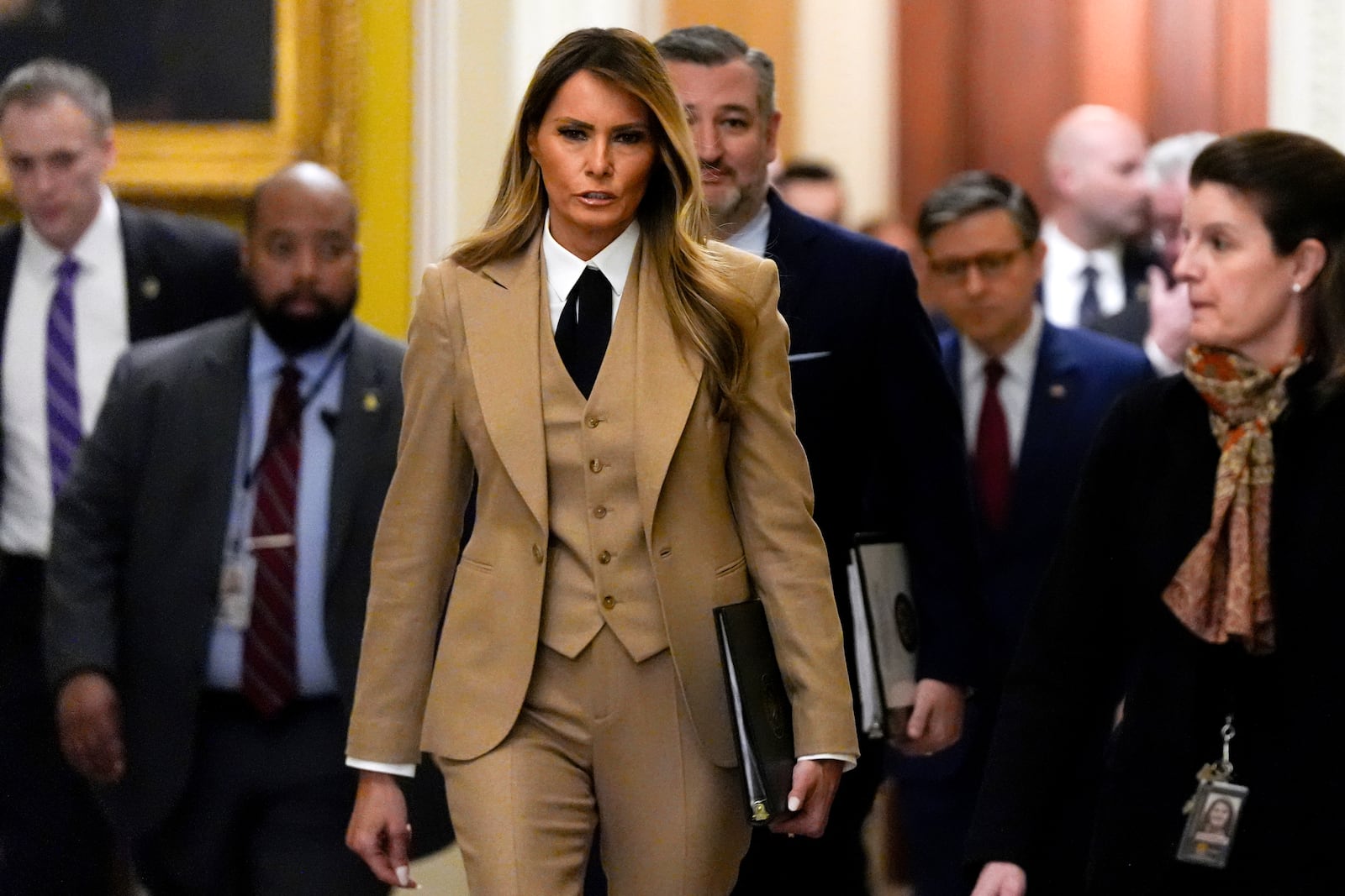 First lady Melania Trump, from center to right, followed by Sen. Ted Cruz, R-Texas, and House Speaker Mike Johnson, R-La., walks through the Capitol, Monday, March 3, 2025, in Washington. (AP Photo/Julia Demaree Nikhinson)