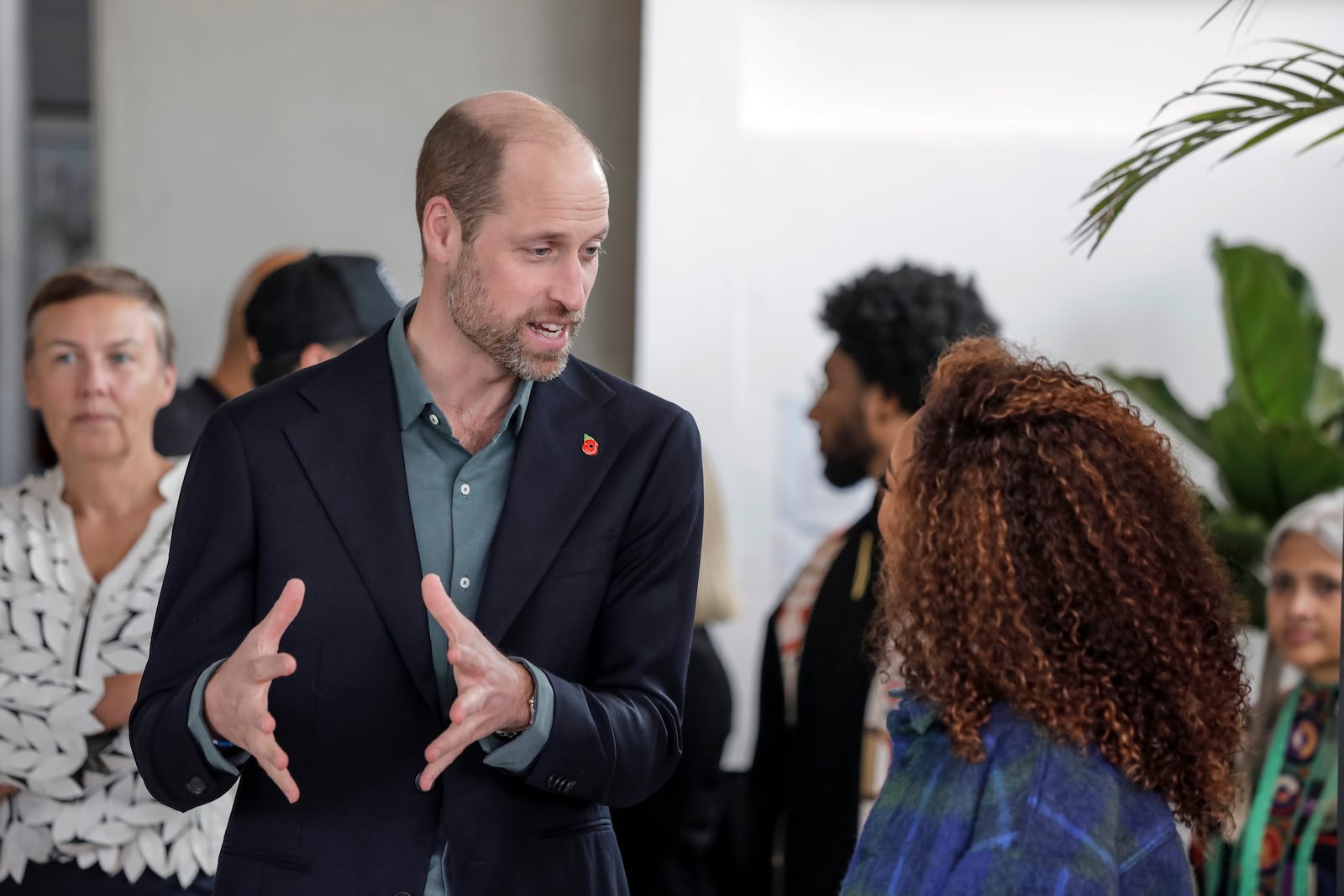 Britain's Prince William, left, speaks to an attendee at the Earthshot Prize Climate Leaders Youth Programme at Rooftop on Bree in Cape Town, South Africa, Monday Nov. 4, 2024. (Gianluigi Guercia/Pool Photo via AP)