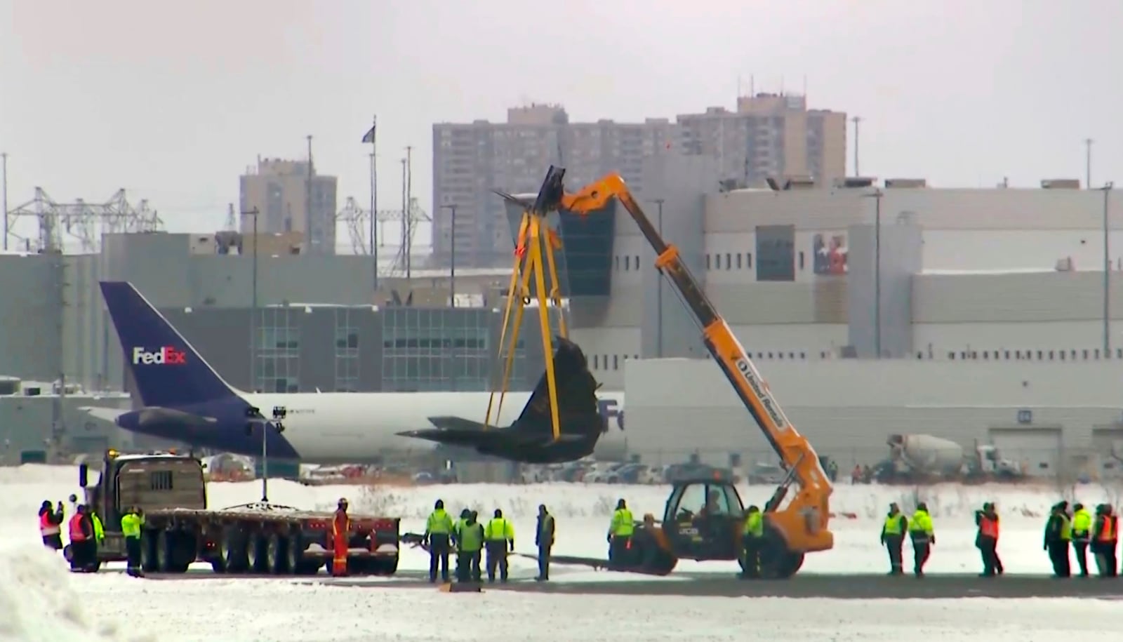 This image taken from video provided by CTV shows a crane lifting debris of a plane at Toronto Pearson Airport on Wednesday, Feb.19, 2025. (CTV via AP)