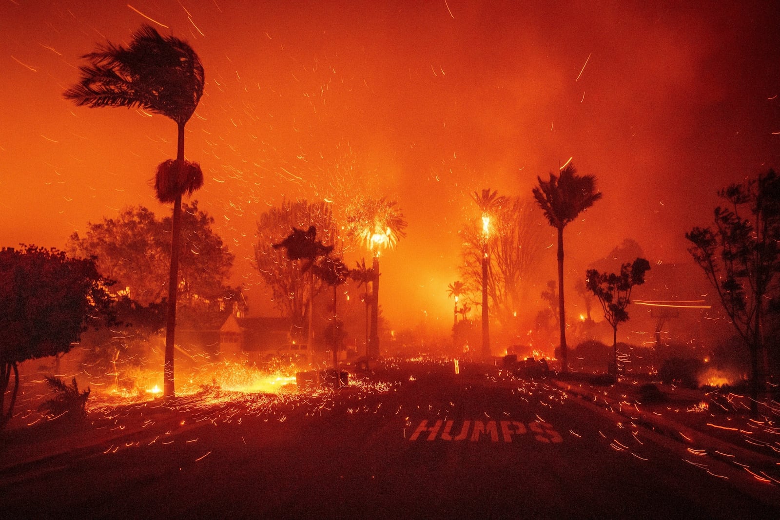 FILE - The Palisades Fire ravages a neighborhood amid high winds in the Pacific Palisades neighborhood of Los Angeles, Jan. 7, 2025. (AP Photo/Ethan Swope, File)