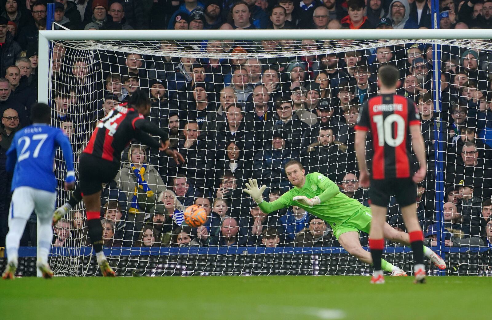 Everton goalkeeper Jordan Pickford dives Bournemouth's Antoine Semenyo scores from the penalty spot during the English FA Cup fourth round soccer match between Everton and Bournemouth at at Goodison Park, Liverpool, England, Saturday, Feb. 8, 2025. (Peter Byrne/PA via AP)