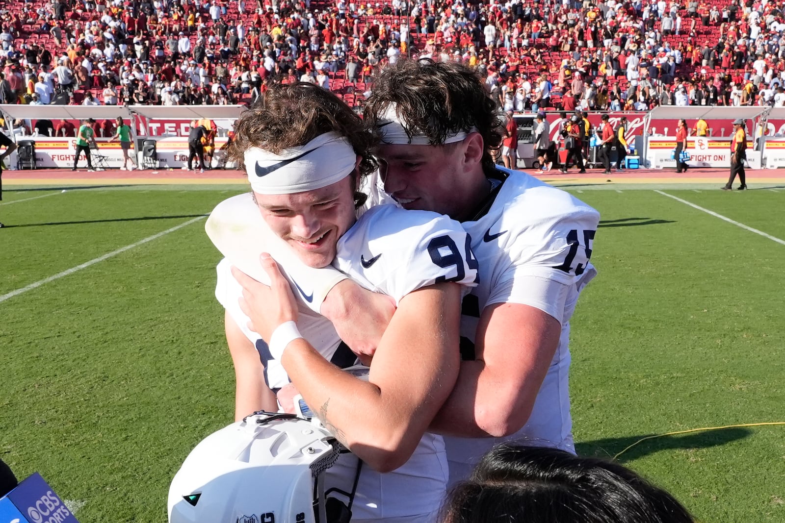 Penn State place kicker Ryan Barker, left, is hugged by quarterback Drew Allar (15) after Barker's game-winning field goal in overtime during an NCAA college football game against Southern California, Saturday, Oct. 12, 2024, in Los Angeles. (AP Photo/Marcio Jose Sanchez)