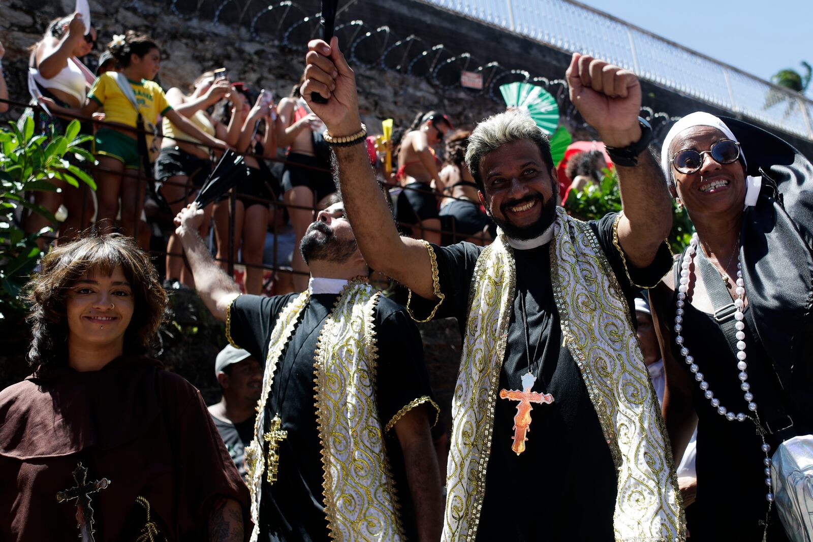 Revelers dressed as priests dance during the Carmelitas street party on the first official day of Carnival in Rio de Janeiro, Friday, Feb. 28, 2025. (AP Photo/Bruna Prado)