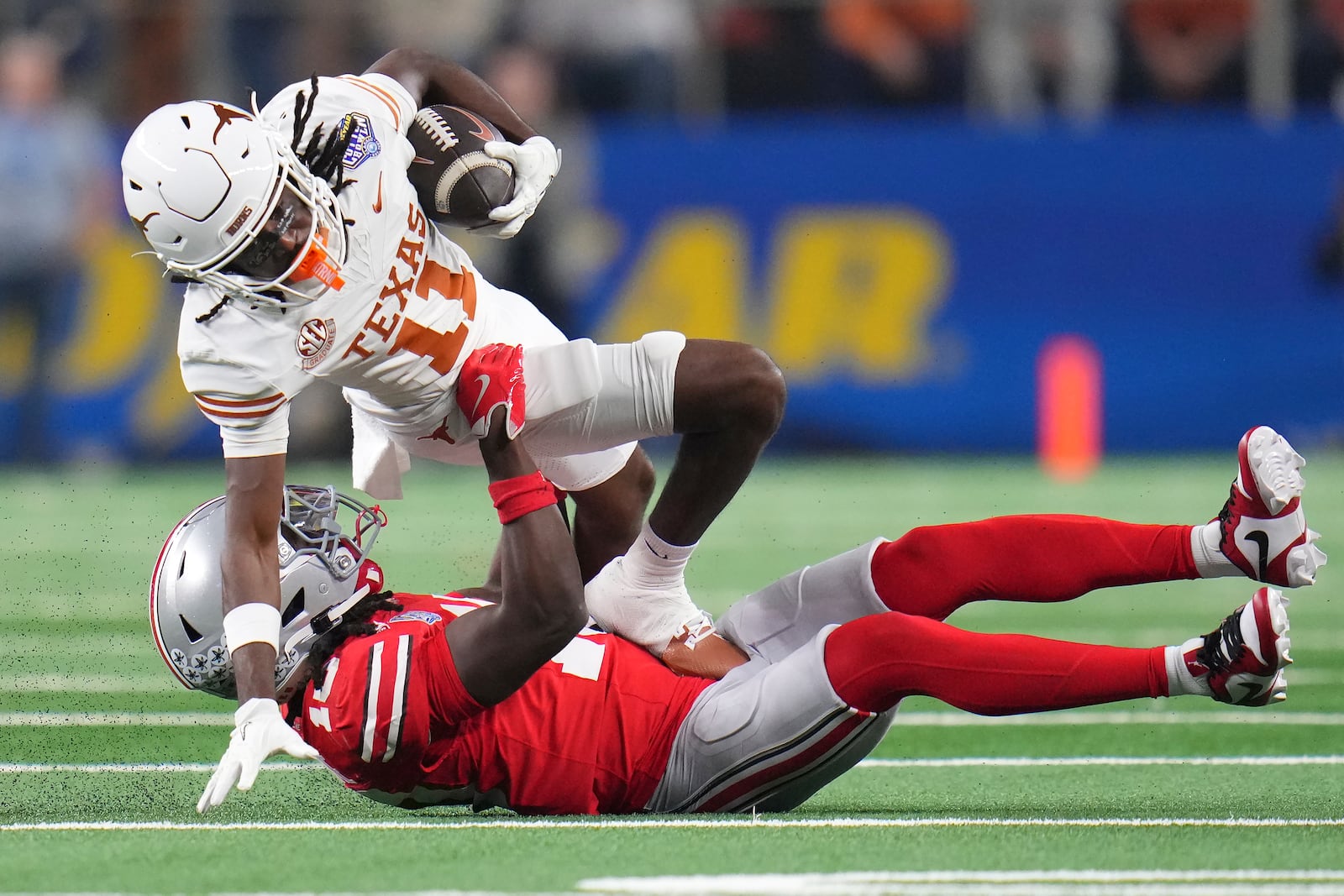 Texas wide receiver Silas Bolden (11) runs against Ohio State cornerback Denzel Burke during the first half of the Cotton Bowl College Football Playoff semifinal game, Friday, Jan. 10, 2025, in Arlington, Texas. (AP Photo/Julio Cortez)