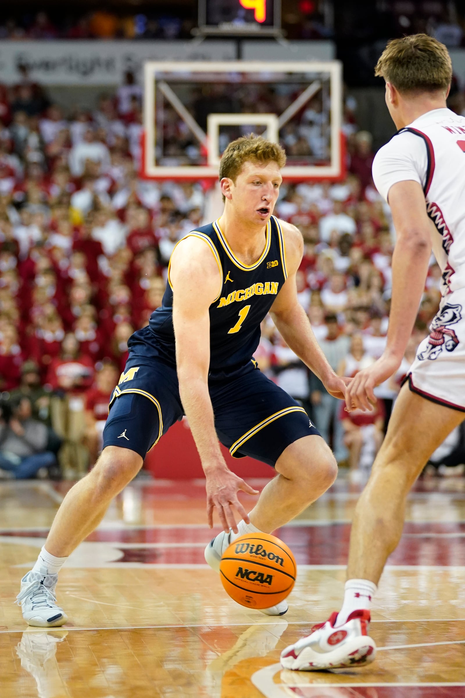 Michigan center Danny Wolf (1) dribbles the ball against Wisconsin forward Nolan Winter (31) during the first half of an NCAA college basketball game Tuesday, Dec. 3, 2024, in Madison, Wis. (AP Photo/Kayla Wolf)