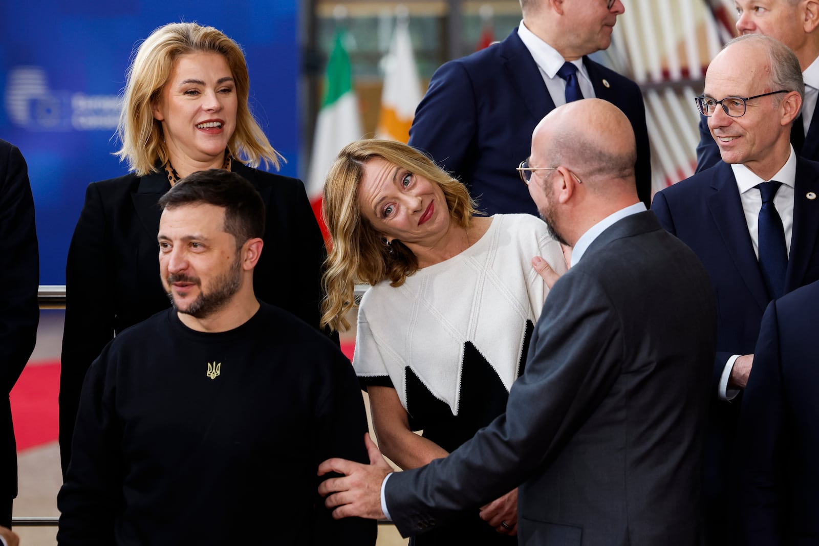 European Council President Charles Michel, second right, talks to Italy's Prime Minister Giorgia Meloni, center, next to Ukraine's President Volodymyr Zelenskyy, bottom left, as they arrive for a group photo during an EU summit in Brussels, Thursday, Oct. 17, 2024. (AP Photo/Geert Vanden Wijngaert)