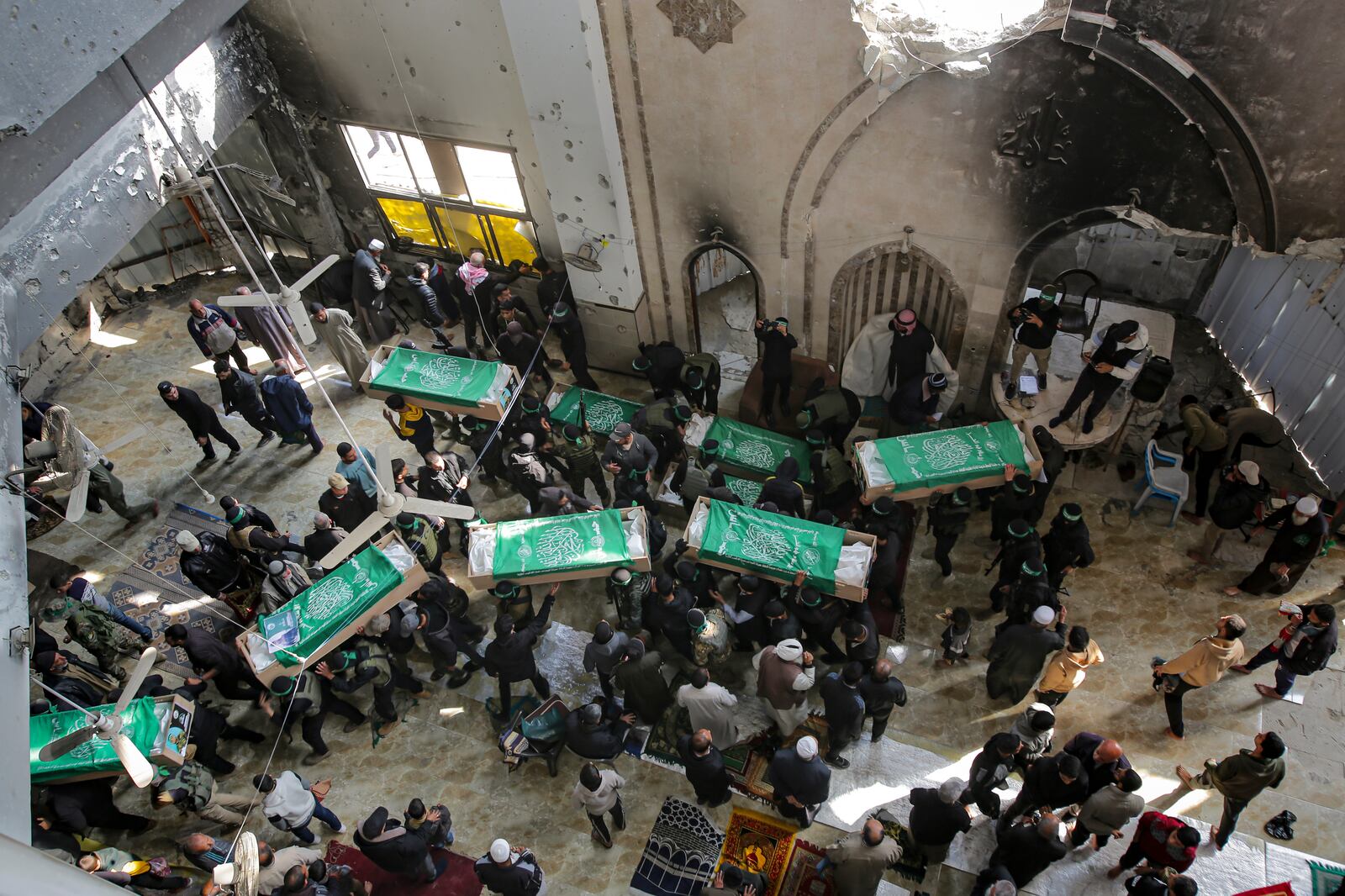 Palestinians carry the bodies of members of the Izzedine al-Qassam Brigades, the military wing of Hamas movement, who were killed in Israeli bombardment of the Gaza Strip, during their funeral in Khan Younis, Friday, Jan. 31, 2025. (AP Photo/Jehad Alshrafi)