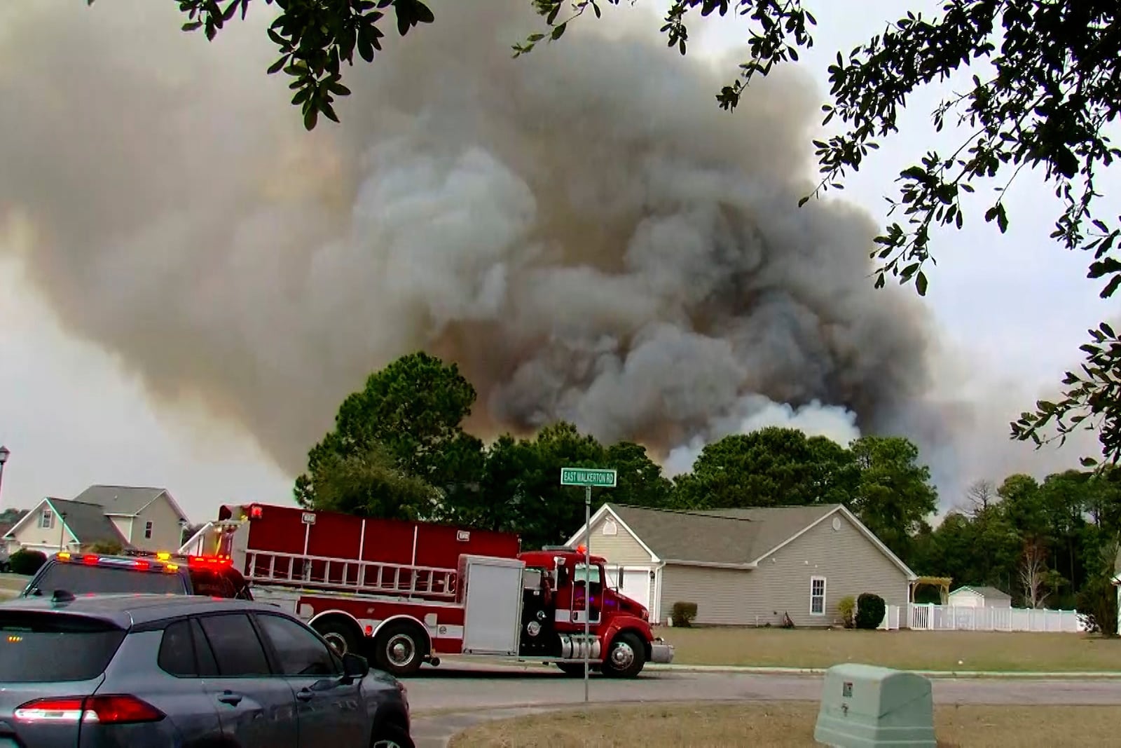 Crews work to contain a fire in the Carolina Forest area west of the coastal resort city of Myrtle Beach, S.C., Sunday, March 2, 2025, where residents were ordered to evacuate several neighborhoods. (WMBF-TV via AP)