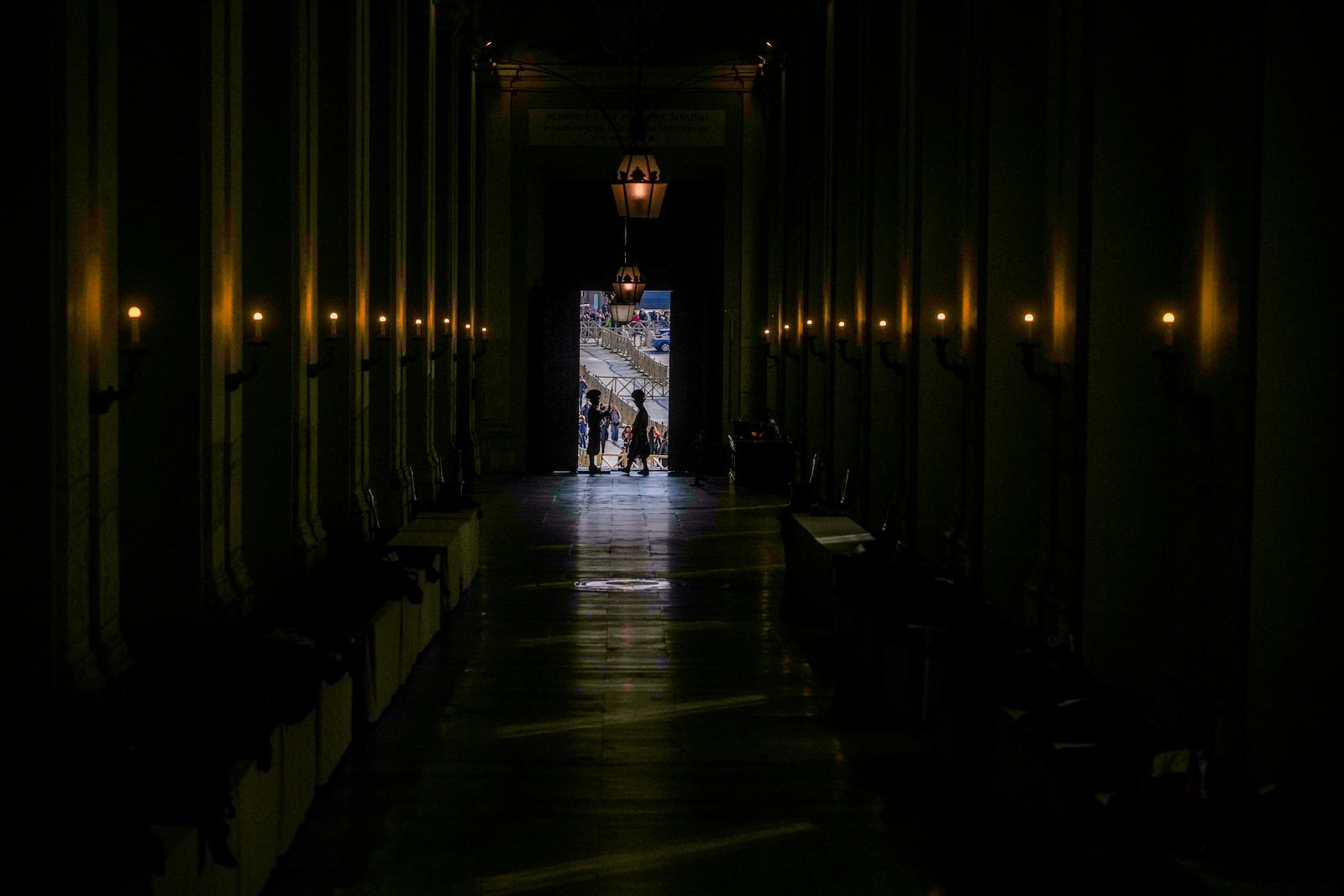 Vatican Swiss guards surveil the Bronze Door, the main entrance to the papal apartments, at The Vatican, Sunday, Feb. 23, 2025, as Pope Francis who was admitted over a week ago at Rome's Agostino Gemelli Polyclinic is in critical conditions. (AP Photo/Alessandra Tarantino)