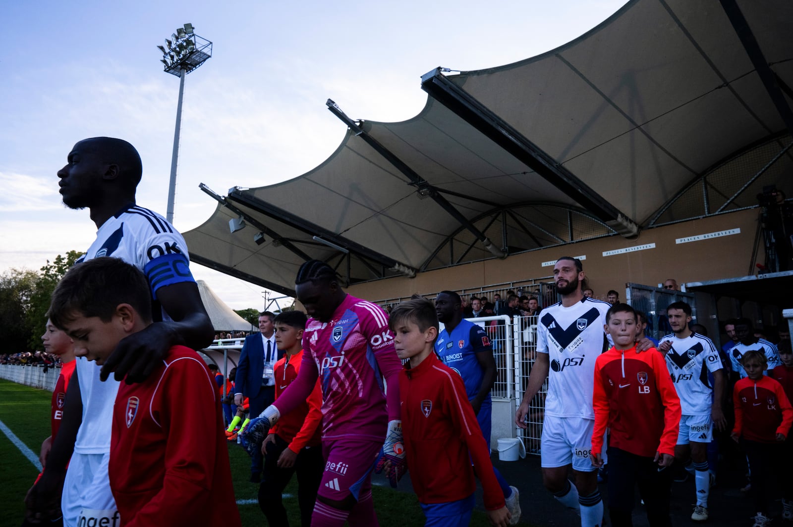 The teams of Bordeaux and Saumur enter the stadium prior to the Championnat National 2 soccer match between Saumur and Bordeaux, in Saumur, France, Saturday, Oct. 5, 2024.(AP Photo/Louise Delmotte)