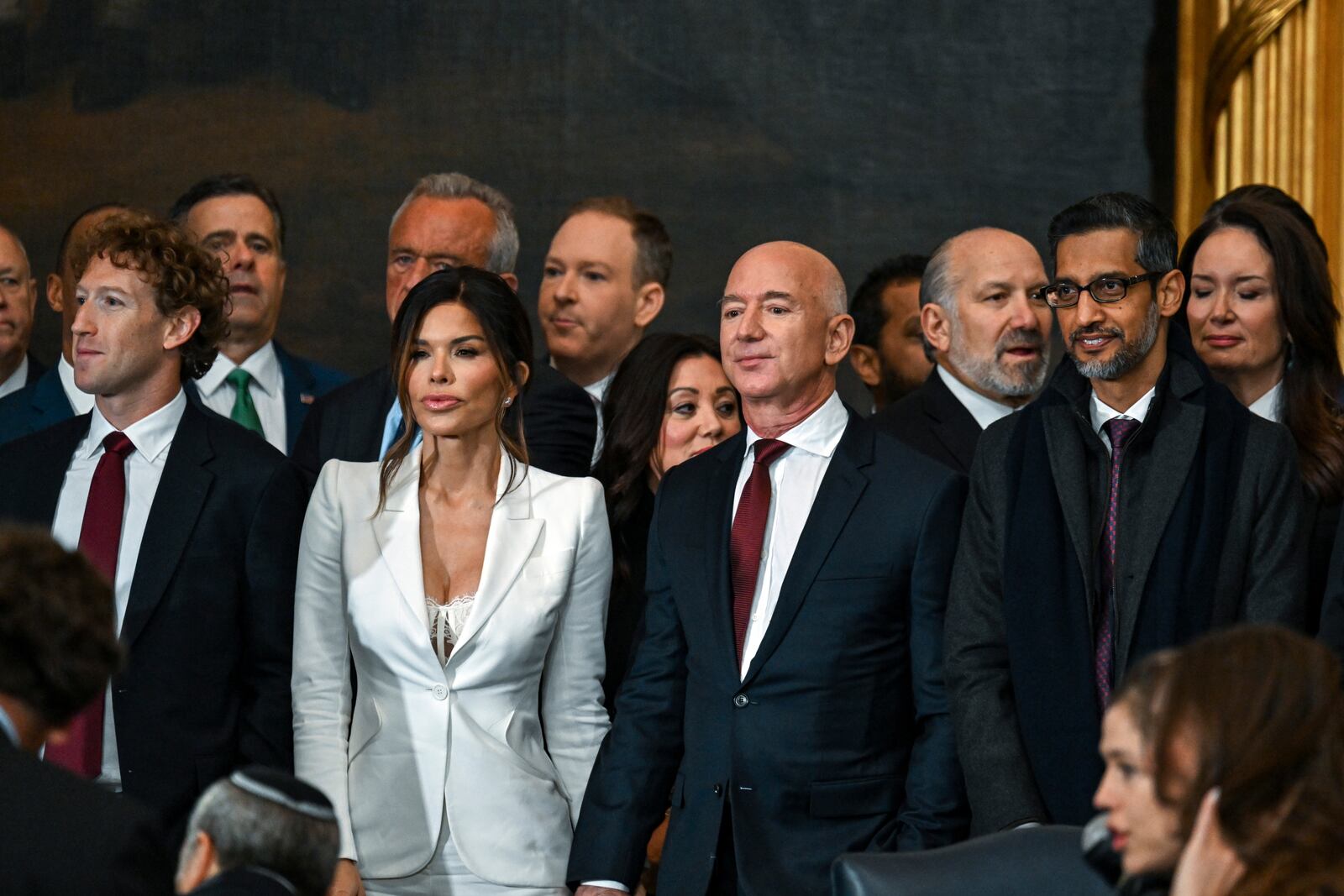 Mark Zuckerberg, from left, Lauren Sanchez, Jeff Bezos and Sundar Pichai stand before the 60th Presidential Inauguration in the Rotunda of the U.S. Capitol in Washington, Monday, Jan. 20, 2025. (Kenny Holston/The New York Times via AP, Pool)