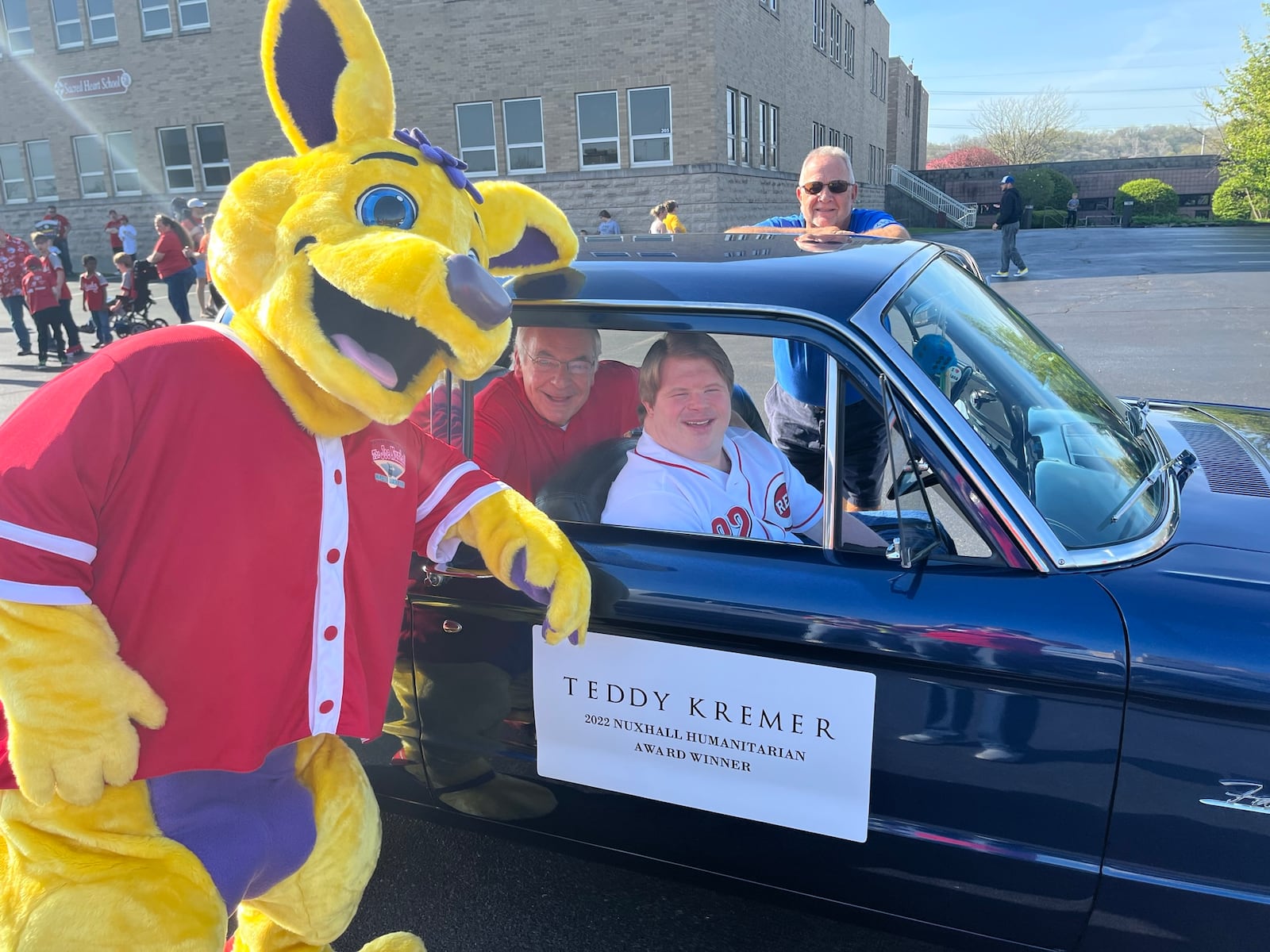 Pictured is Joey, the Miracle League mascot, and 2022 Nuxhall Foundation Humanitarian Award Winner Teddy Kremer ahead of the 2022 Joe Nuxhall Miracle League Field Opening Day Parade. This year's parade is set for this Saturday, April 22, 2023, starting at Sacred Heart Church on Nilles Road and ending at the Miracle League Fields on Groh Lane. PROVIDED