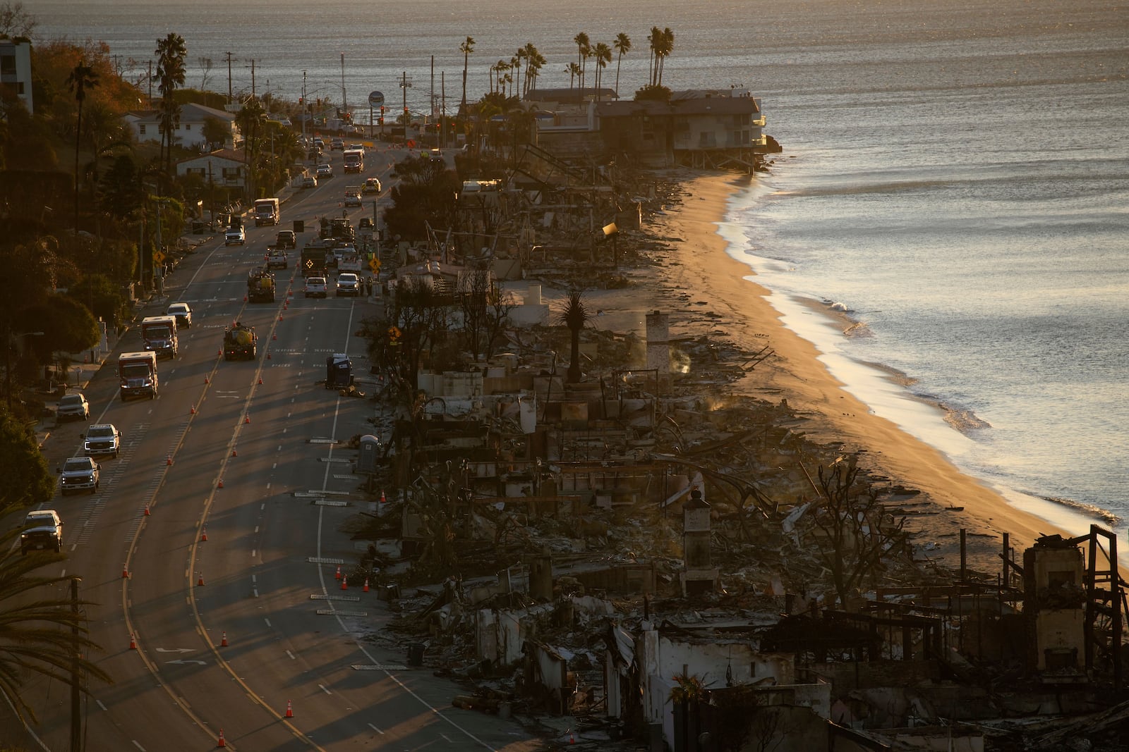 Homes along Pacific Coast Highway are left burned to the ground in the aftermath of the Palisades Fire Monday, Jan. 13, 2025 in Malibu, Calif. (AP Photo/John Locher)