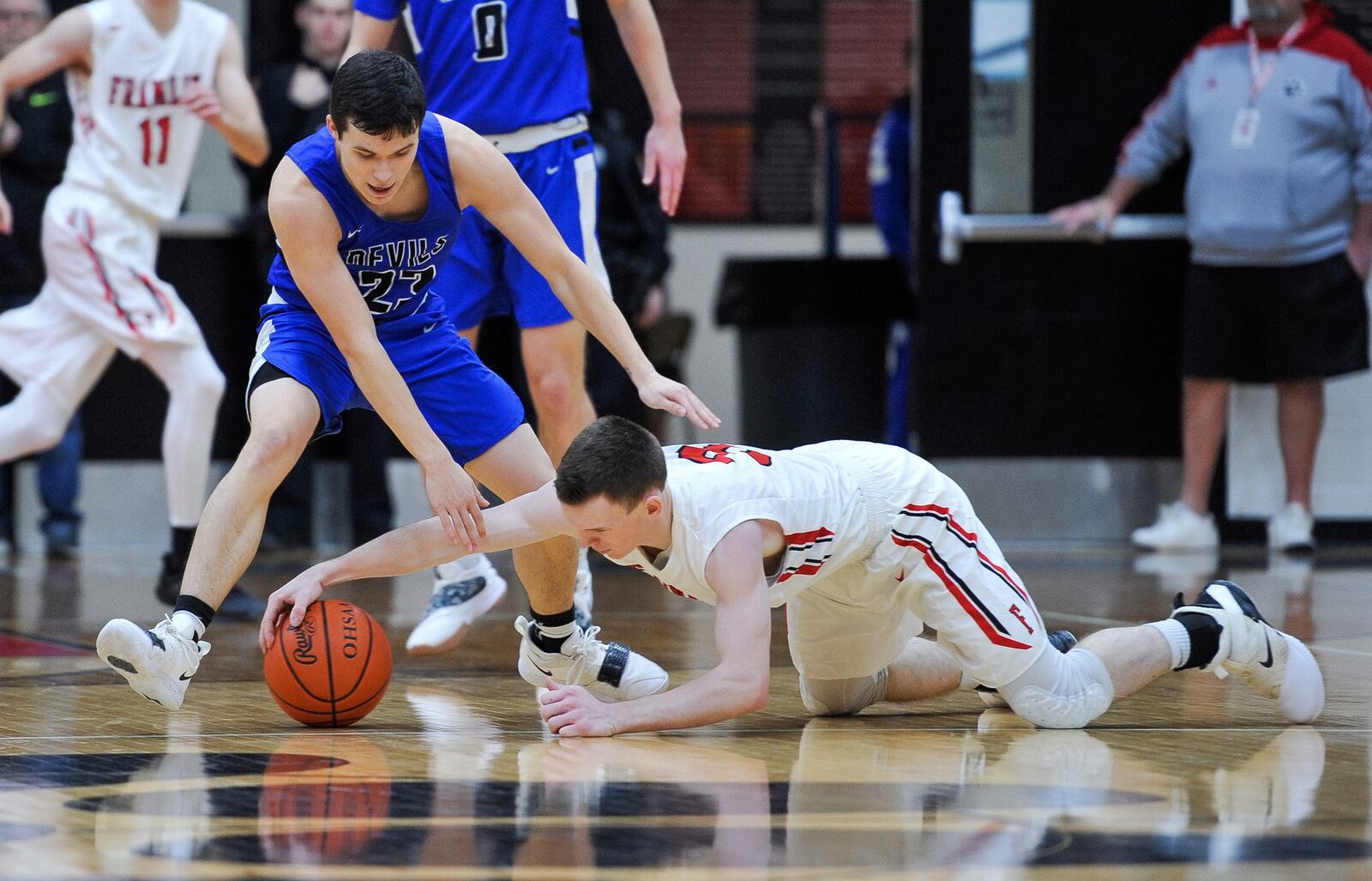 Brookville’s Wade Turner (left) and Franklin’s Zack Minton fight for a loose ball during Friday night’s game at Darrell Hedric Gym in Franklin. The host Wildcats won 72-68 in overtime. NICK GRAHAM/STAFF