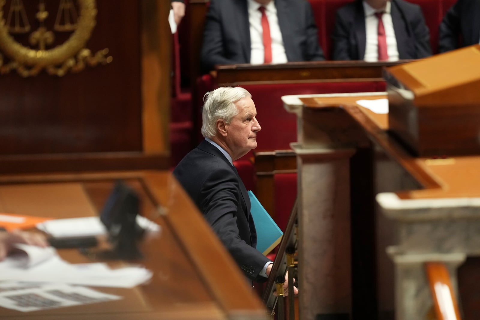 French Prime Minister Michel Barnier leaves after addressing the National Assembly prior to a vote on a no-confidence motion that could bring him down and his cabinet for the first time since 1962, Wednesday, Dec. 4, 2024 in Paris. (AP Photo/Michel Euler)