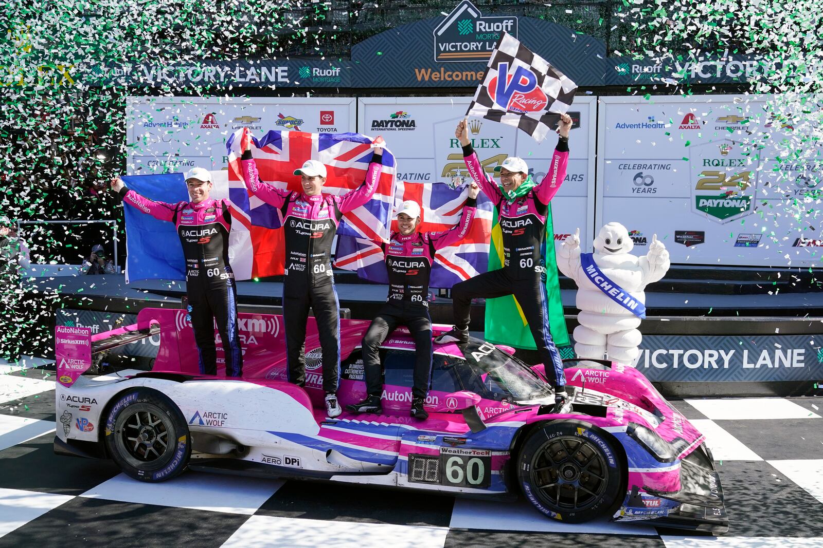 FILE - Winners of the Rolex 24 hour auto race, from left, Simon Pagenaud, of France, Oliver Jarvis, of Great Britain, Tom Blomqvist, of Monaco and Helio Castroneves, of Brazil celebrate in Victory Lane at Daytona International Speedway, Jan. 30, 2022, in Daytona Beach, Fla. (AP Photo/John Raoux, File)