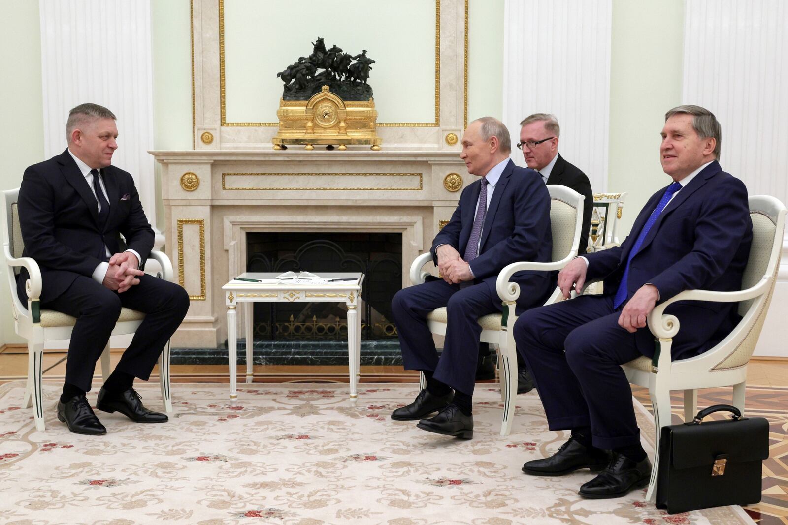 Russian President Vladimir Putin, 3rd right, speaks with Slovak Prime Minister Robert Fico, left, during their meeting at the Kremlin in Moscow, Russia, Sunday, Dec. 22, 2024. (Gavriil Grigorov, Sputnik, Kremlin Pool Photo via AP)