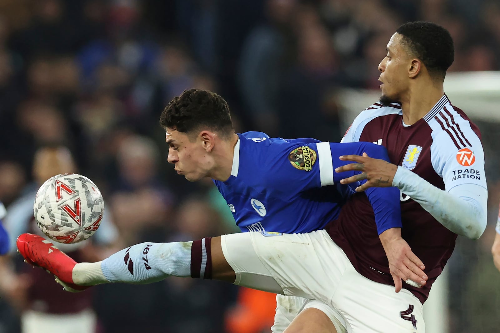 Aston Villa's Ezri Konsa, right, and Cardiff City's Yousef Salech challenge for the ball during the English FA Cup fifth round soccer match between Aston Villa and Cardiff City at the Villa Park stadium in Birmingham, England, Friday, Feb. 28, 2025. (AP Photo/Darren Staples)