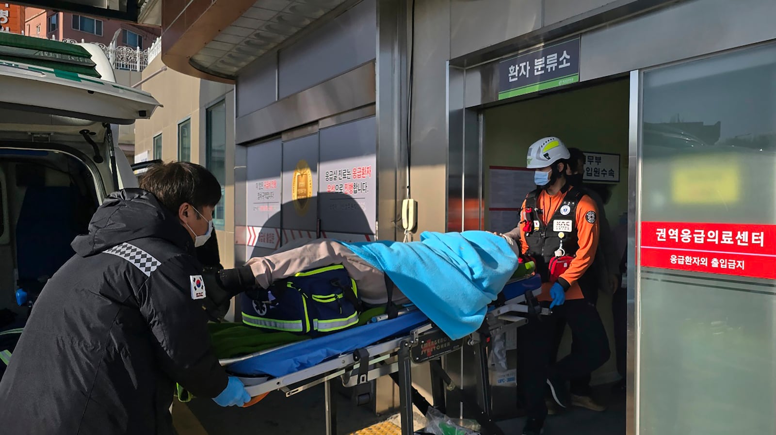 A victim rescued from a plane crash is transported to a hospital in Mokpo, South Korea, Sunday, Dec. 29, 2024. (Cho Geun-young/Yonhap via AP)