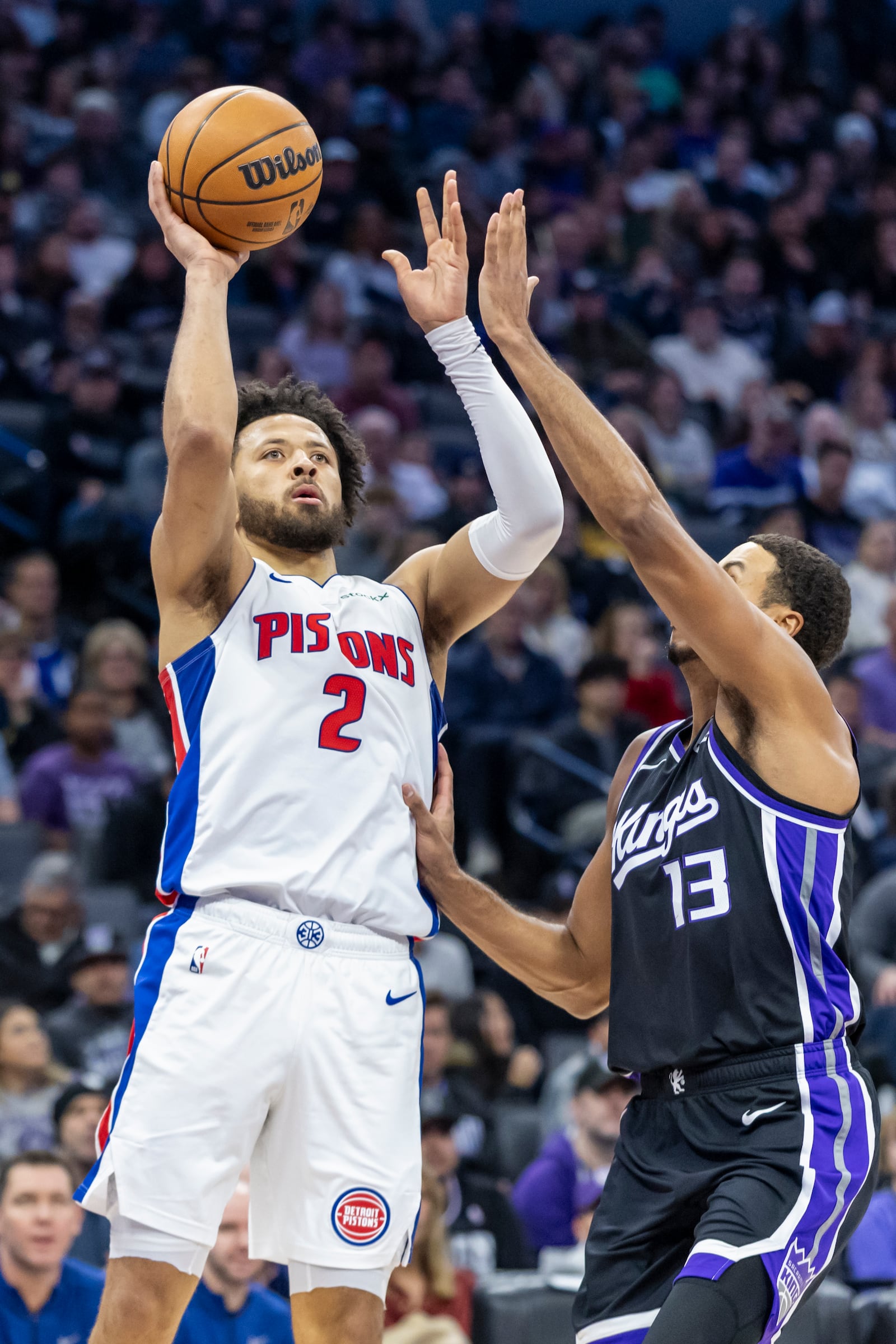 Detroit Pistons guard Cade Cunningham (2) attempts to shoot over Sacramento Kings forward Keegan Murray (13) during the first half of an NBA basketball game Thursday, Dec. 26, 2024, in Sacramento, Calif. (AP Photo/Sara Nevis)