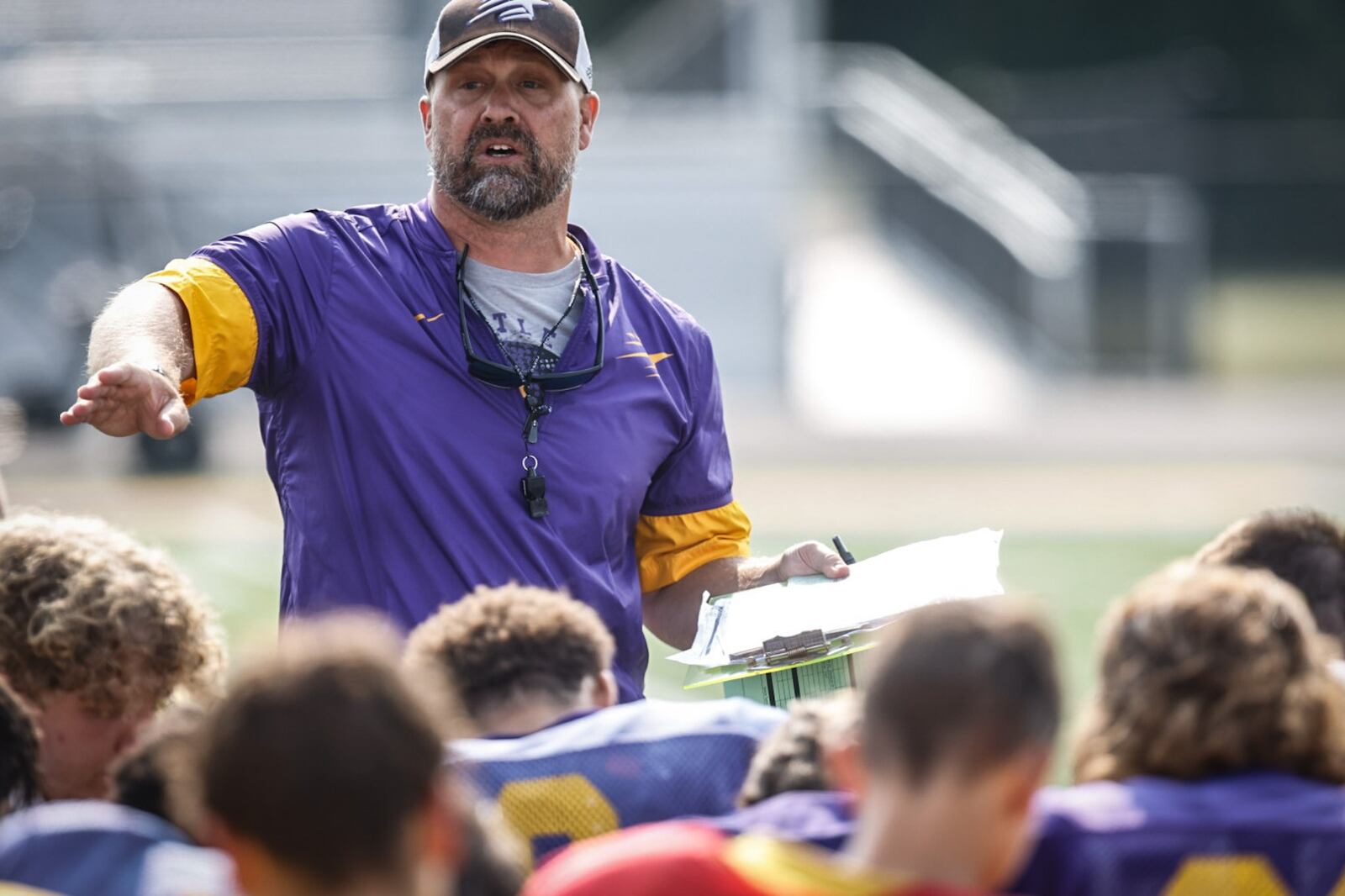 Butler High School football coach Zach Gueth talks to his team after practice Wednesday August 2, 2023. JIM NOELKER/STAFF