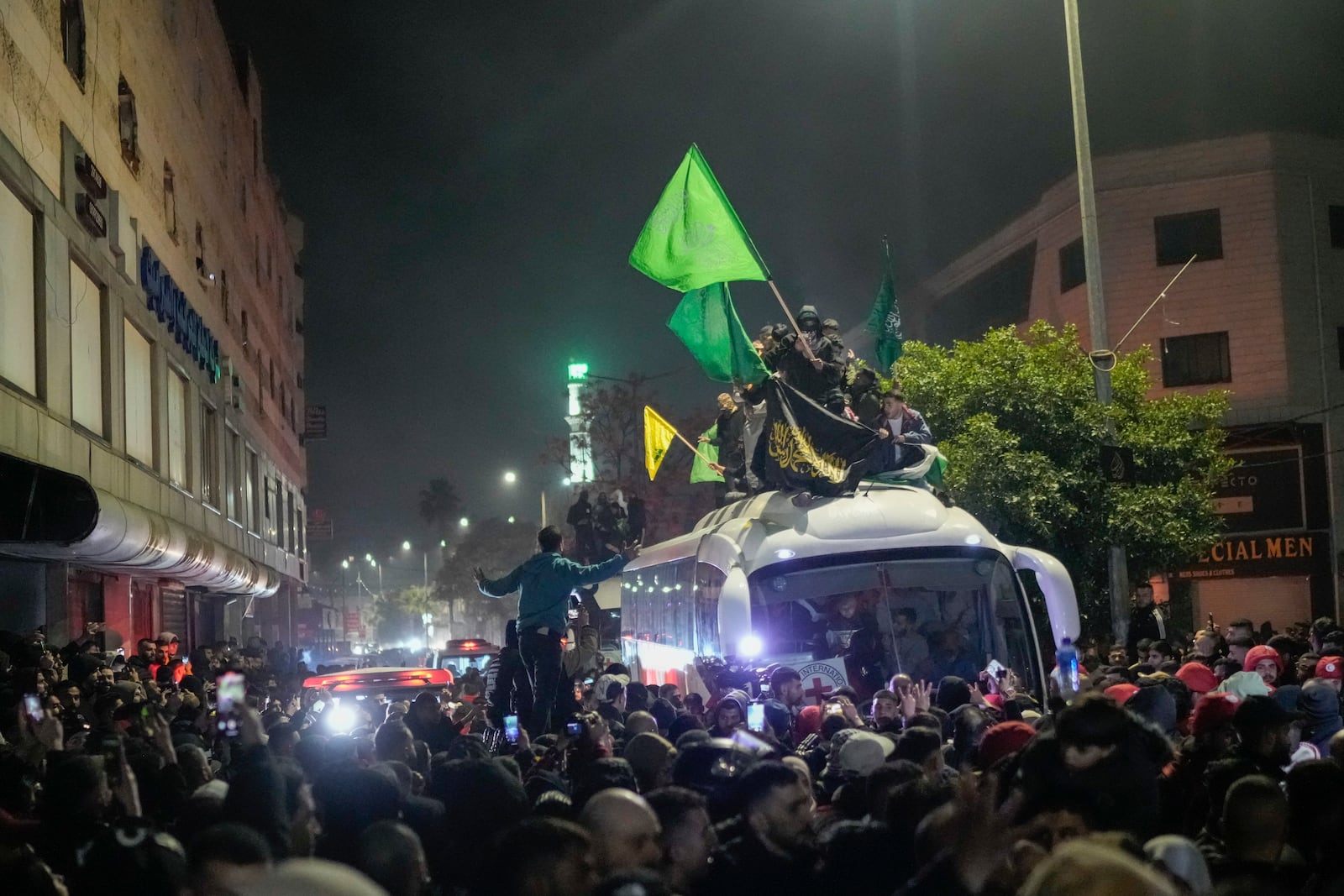 A bus carrying released Palestinian prisoners arrives to the West Bank city of Beitunia, early Monday Jan. 20, 2025. (AP Photo/Leo Correa)