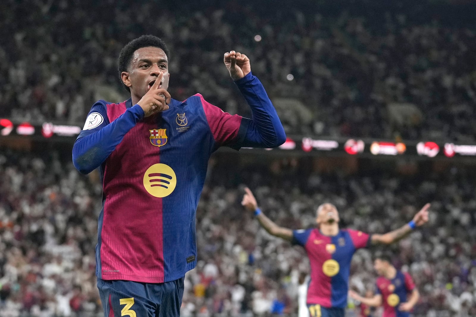 Barcelona's Alejandro Balde celebrates after scoring his side's fourth goal during the Spain Super Cup final soccer match between Real Madrid and Barcelona at King Abdullah Stadium in Jeddah, Saudi Arabia, Sunday, Jan. 12, 2025. (AP Photo/Altaf Qadri)