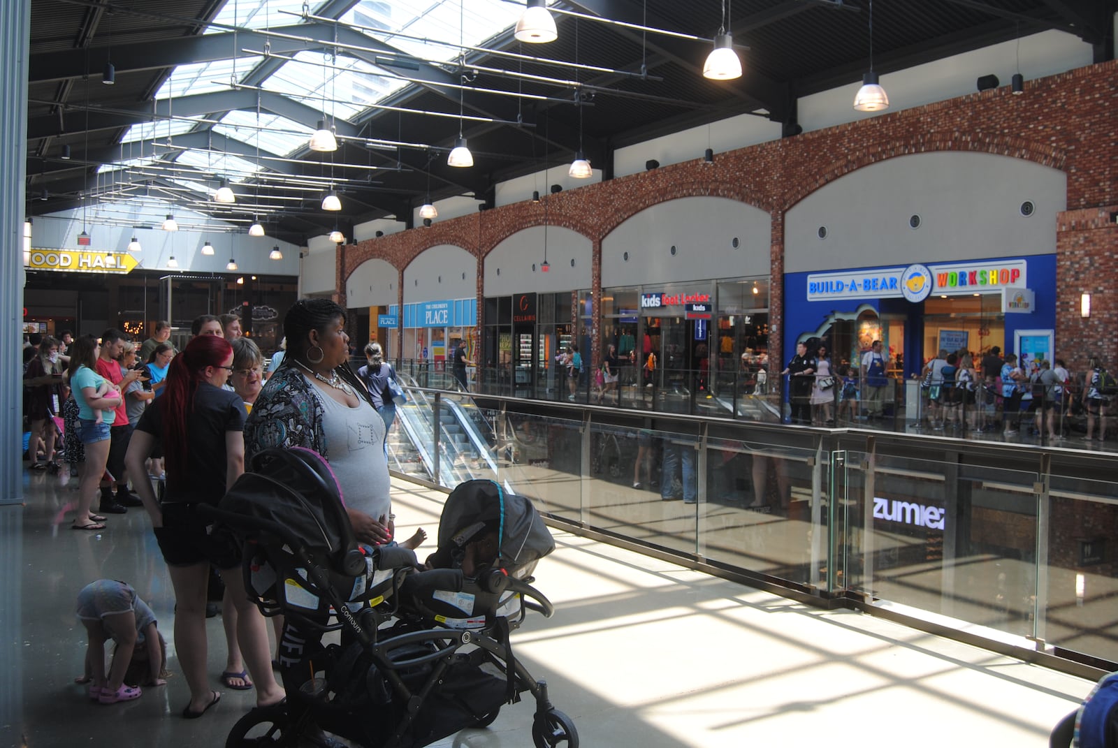 Shoppers wait to enter Build-A-Bear Workshop at Liberty Center on Thursday, July 12, 2018.