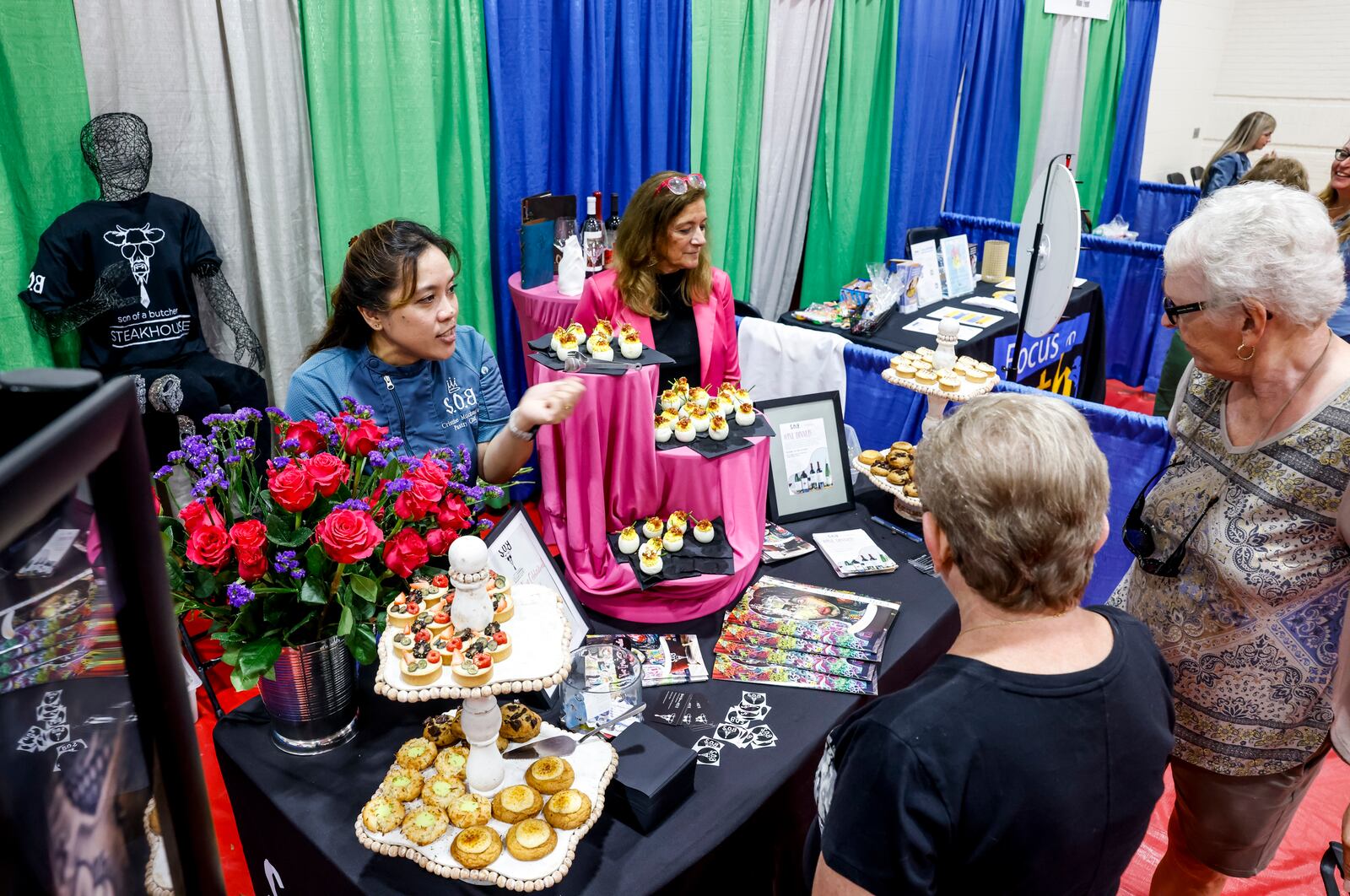 Local businesses and other attendees gathered at Lakota West High School for the West Chester Liberty Chamber alliance Regional Business Expo Tuesday, July 16, 2024 in West Chester Township. Son of a Butcher Steak House had a variety of desserts and other food items for attendees. NICK GRAHAM/STAFF