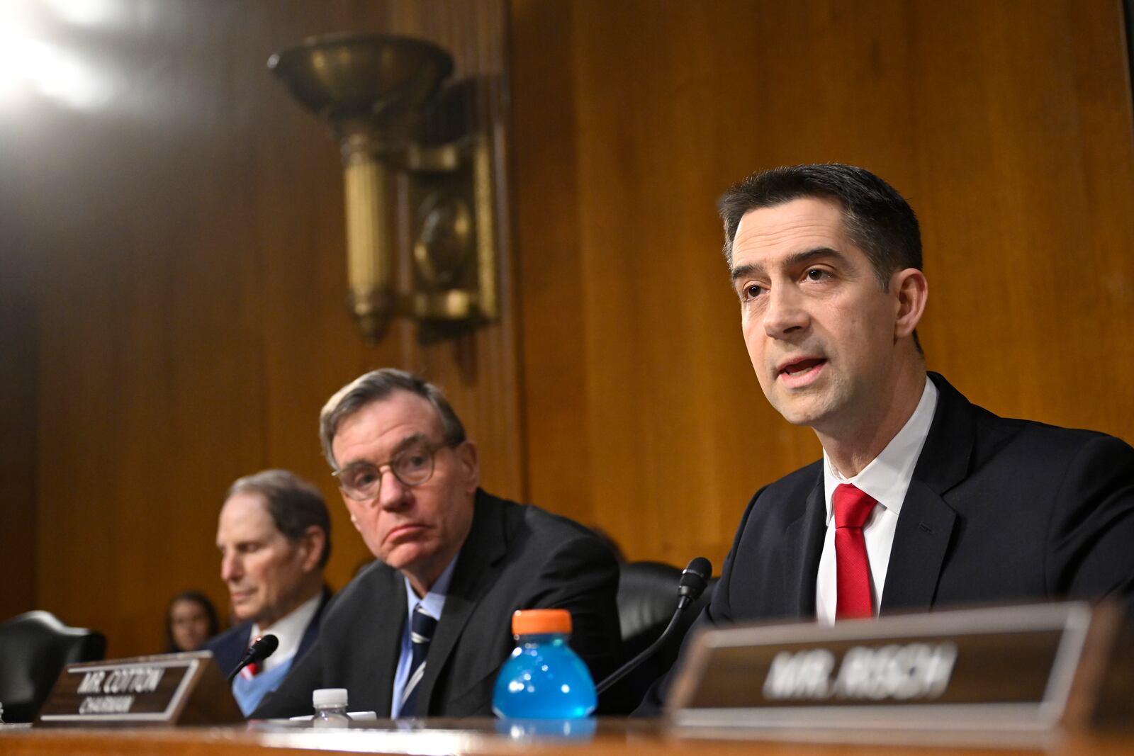 Chairman Sen. Tom Cotton, R-Ark., right, questions former Rep. Tulsi Gabbard, President Donald Trump's nominee to be the Director of National Intelligence, as Vice Chair Sen. Mark Warner, D-Va., center, listens during the Senate Intelligence Committee for Gabbard's confirmation hearing at the U.S. Capitol on Thursday, Jan. 30, 2025, in Washington. (AP Photo/John McDonnell)