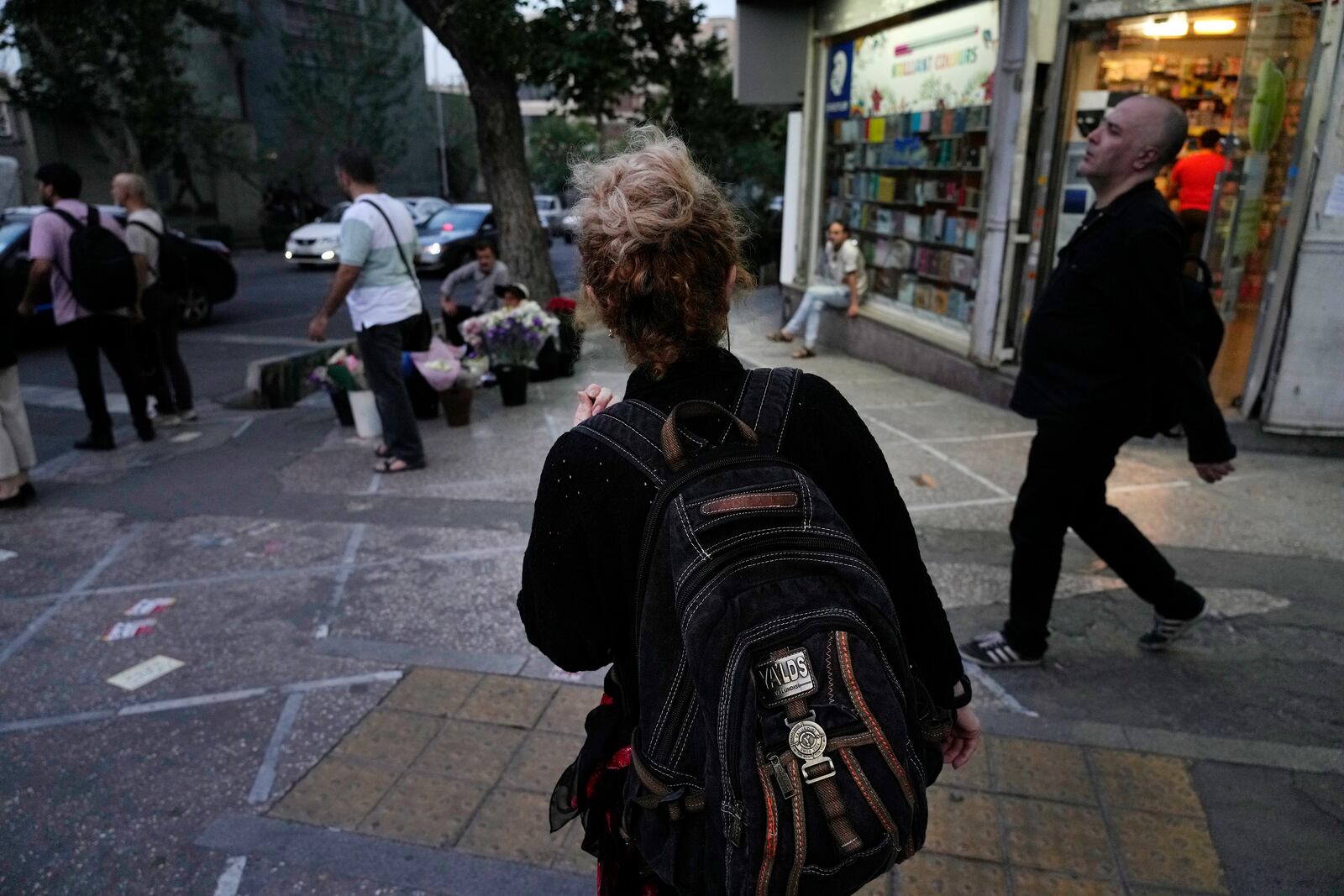 FILE - An Iranian woman, without a mandatory headscarf, or hijab, walks in downtown Tehran, Iran, June 10, 2024. (AP Photo/Vahid Salemi, File)