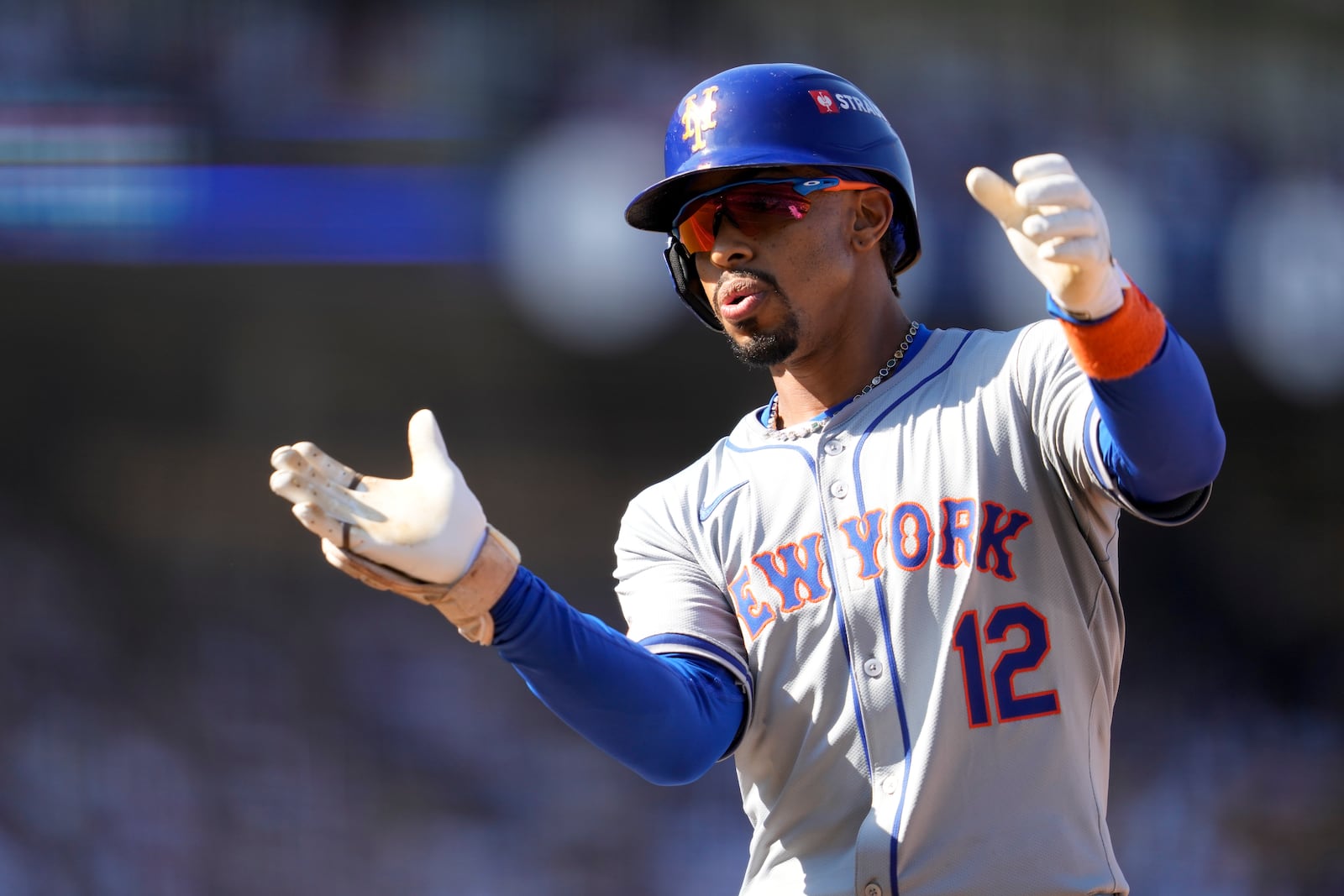 New York Mets' Francisco Lindor celebrates after reaching first base on a throwing error from Los Angeles Dodgers third baseman Max Muncy during the sixth inning in Game 2 of a baseball NL Championship Series, Monday, Oct. 14, 2024, in Los Angeles. (AP Photo/Ashley Landis)