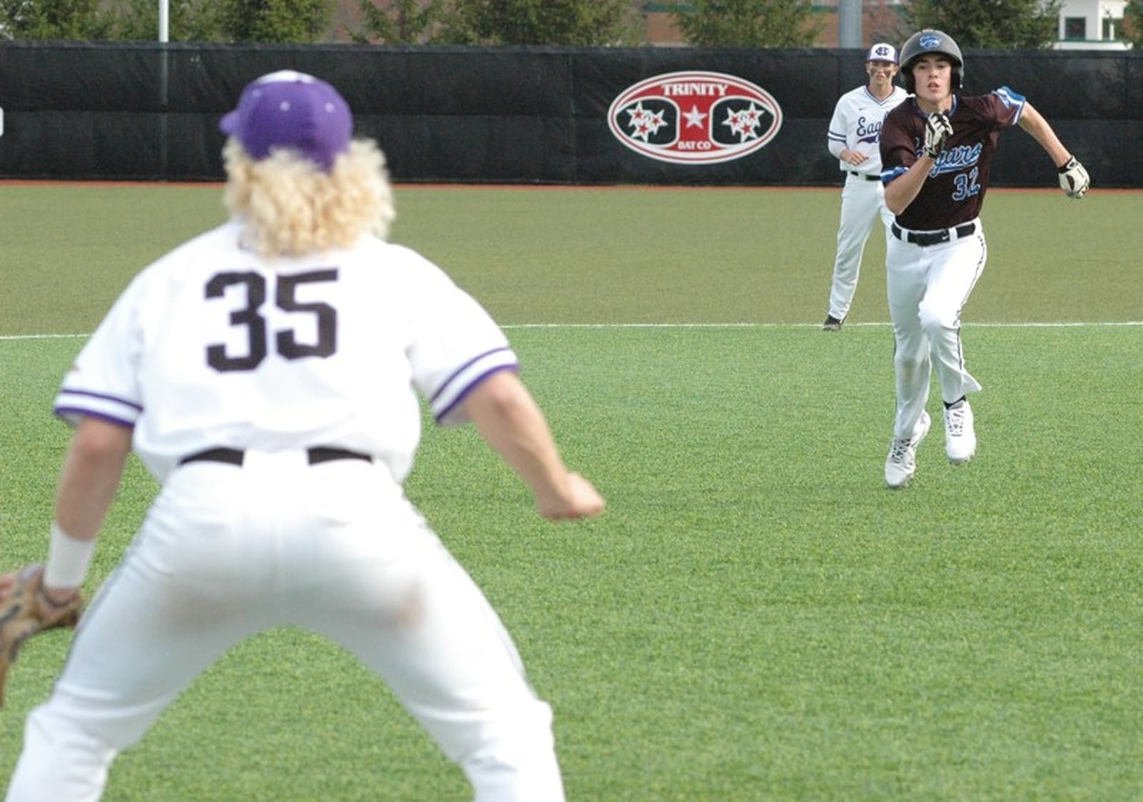 Cincinnati Christian’s Tim Carangi (32) heads toward Cincinnati Hills Christian Academy third baseman Lucas Rotello (35) on April 11 during a Miami Valley Conference baseball game at Prasco Park’s Legacy Field in Mason. CHCA won 3-2. RICK CASSANO/STAFF