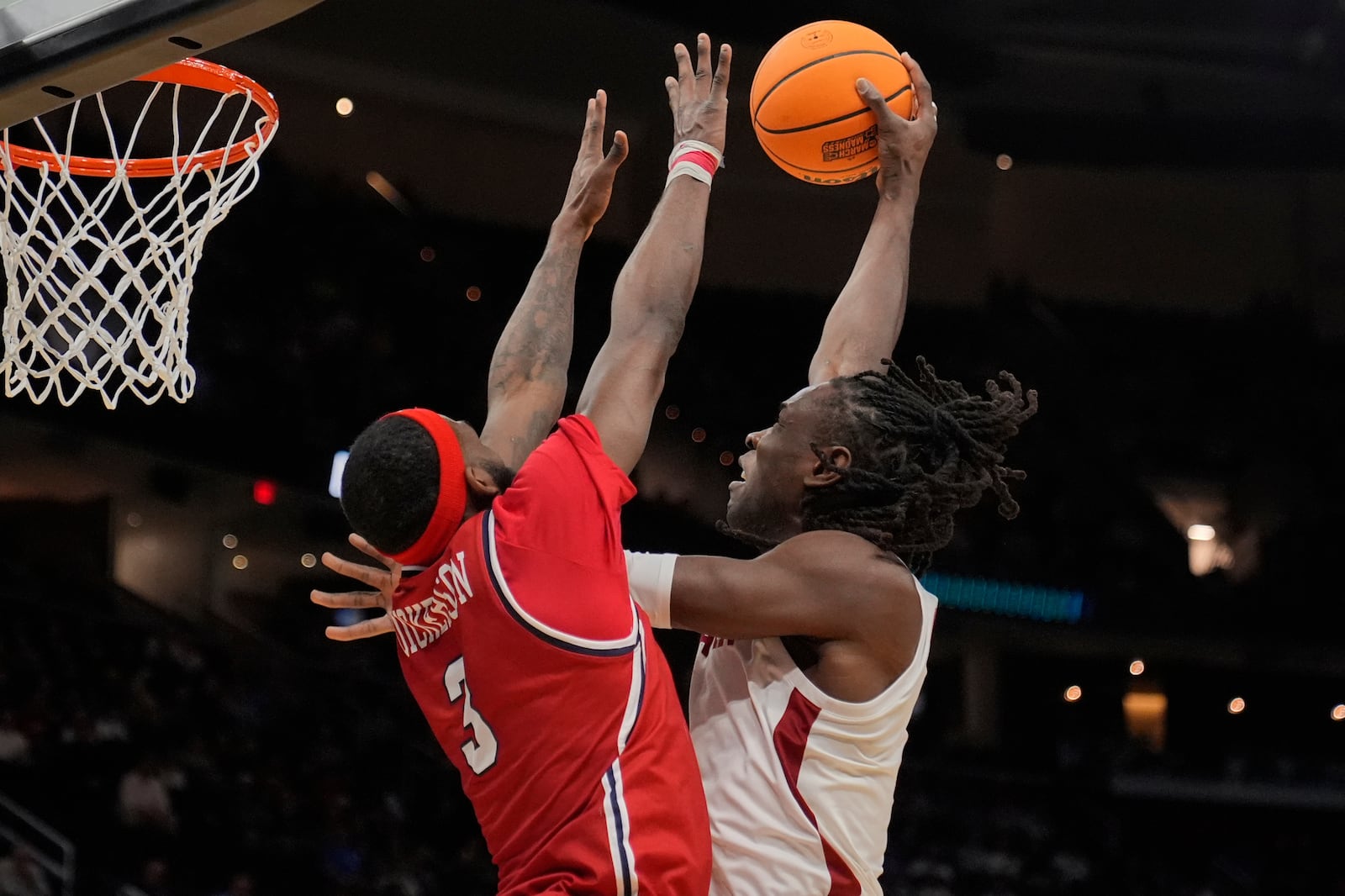 Alabama center Clifford Omoruyi, right, shoots as Robert Morris guard Amarion Dickerson (3) defends in the first half in the first round of the NCAA college basketball tournament, Friday, March 21, 2025, in Cleveland. (AP Photo/Sue Ogrocki)