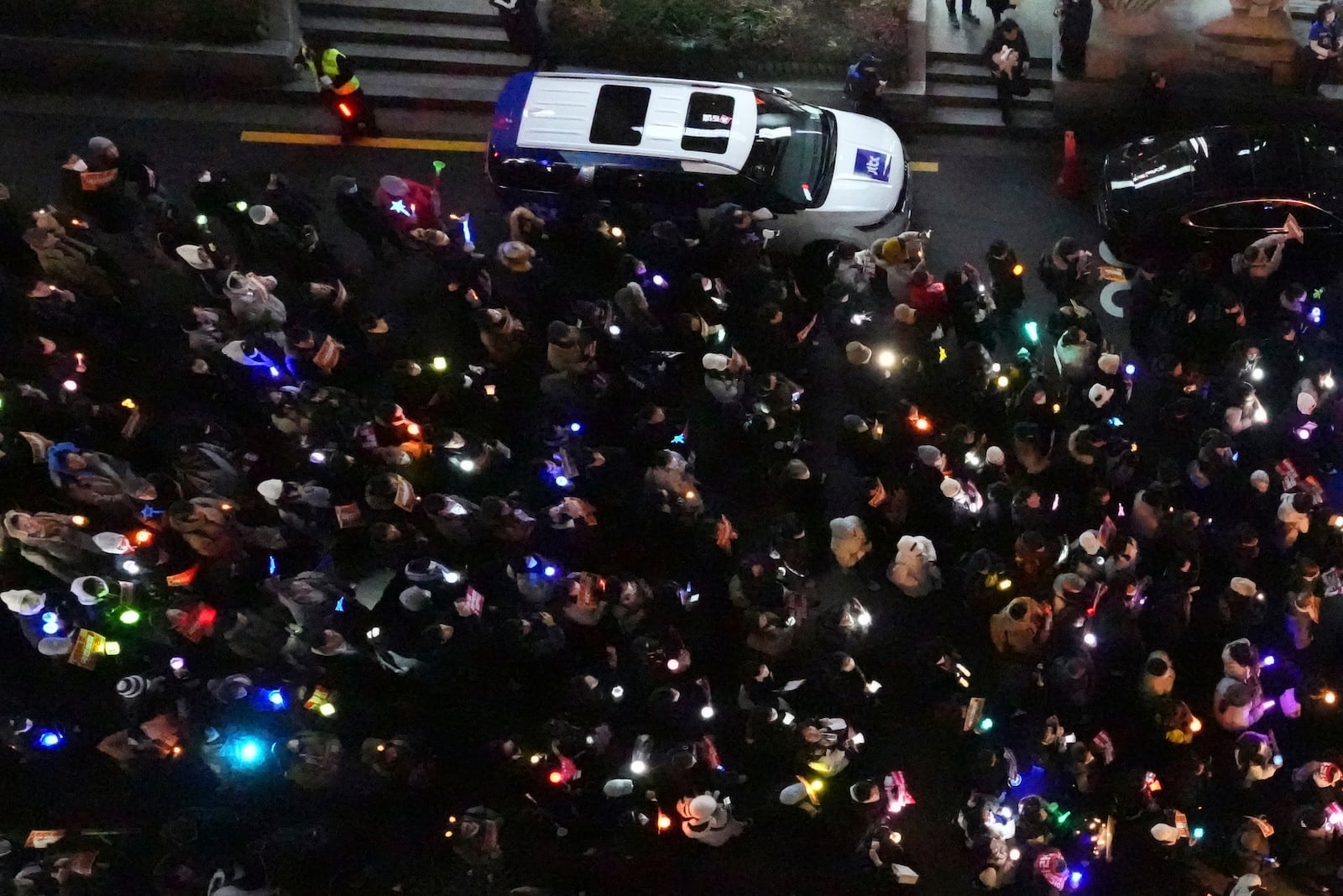 Participants gather to stage a rally demanding South Korean President Yoon Suk Yeol's impeachment, in front of the headquarters of the ruling People Power Party in Seoul, South Korea, Tuesday, Dec. 10, 2024. (AP Photo/Lee Jin-man)