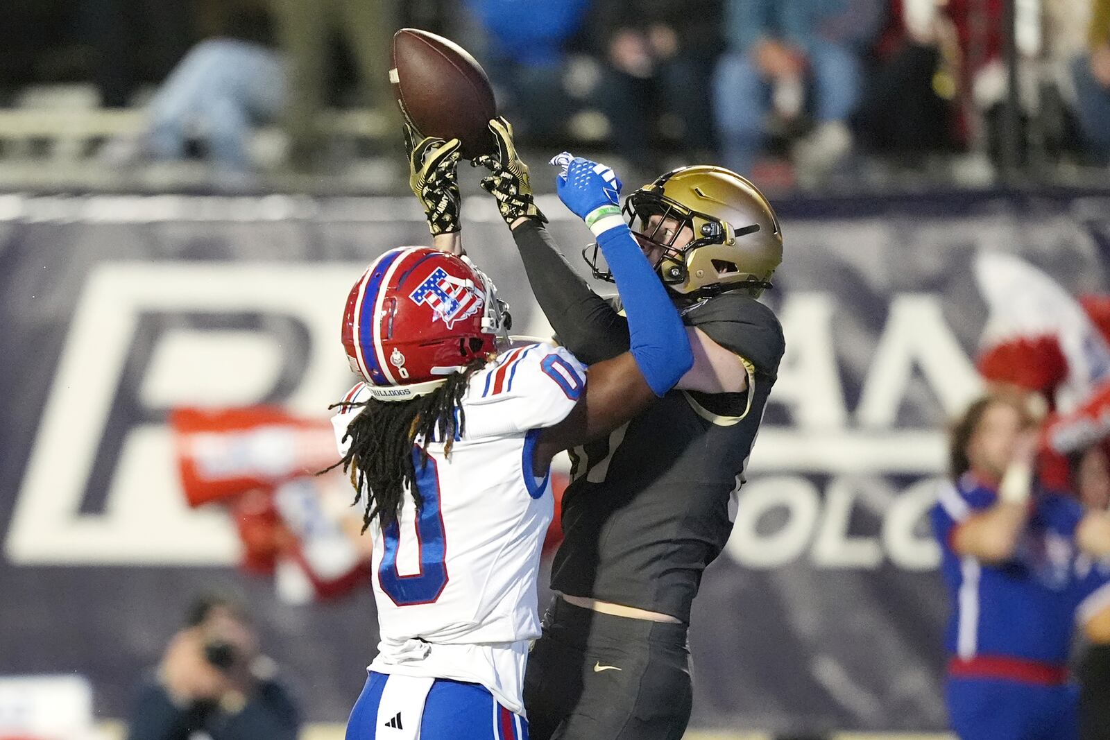 Louisiana Tech defensive back Blake Thompson (0) breaks up a pass to Army wide receiver Casey Reynolds (87) during the first half of the Independence Bowl NCAA college football game, Saturday, Dec. 28, 2024, in Shreveport, La. (AP Photo/Rogelio V. Solis)