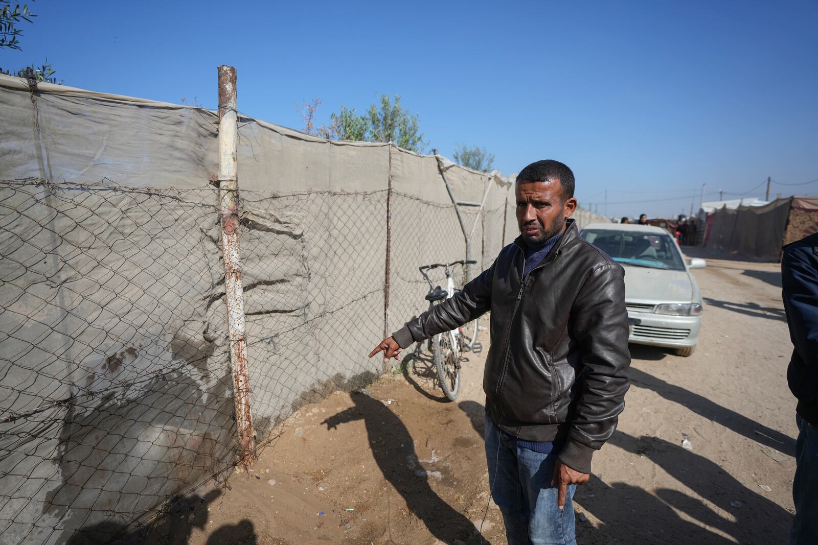 Mahmoud bin Hassan shows the spot where his three children were killed during an Israeli strike in Khan Younis, Gaza Strip, Thursday Nov. 21, 2024. Seven-year-old Hamza, his five-year-old brother Abdelaziz, and his four-year-old sister Laila Hassan were among 9 people killed by an Israeli strike in Khan Younis on Wednesday. Palestinian health officials say the death toll in the Gaza Strip from the 13-month-old war between Israel and Hamas has surpassed 44,000. (AP Photo/Abdel Kareem Hana)