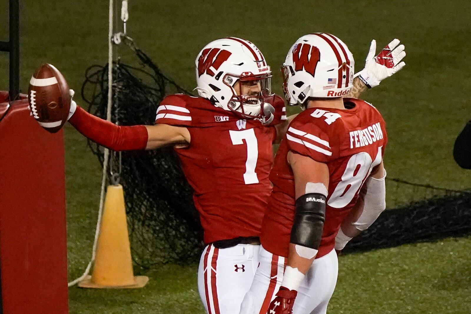 FILE - In this Oct. 23, 2020, file photo, Wisconsin wide receiver Danny Davis III celebrates a touchdown catch with Jake Ferguson (84) during the first half of an NCAA college football game against Illinois in Madison, Wis. Wisconsin is cautiously optimistic that a year full of adversity on and off the field will help its passing attack live up to the promise it showed last season.  (AP Photo/Morry Gash, File)