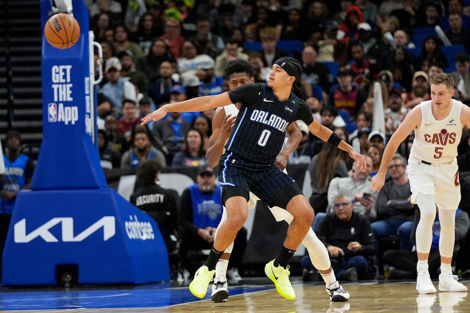 Orlando Magic guard Anthony Black (0) loses control of the ball in front of Cleveland Cavaliers forward De'Andre Hunter, back left, and guard Sam Merrill (5) during the second half of an NBA basketball game, Tuesday, Feb. 25, 2025, in Orlando, Fla. (AP Photo/John Raoux)