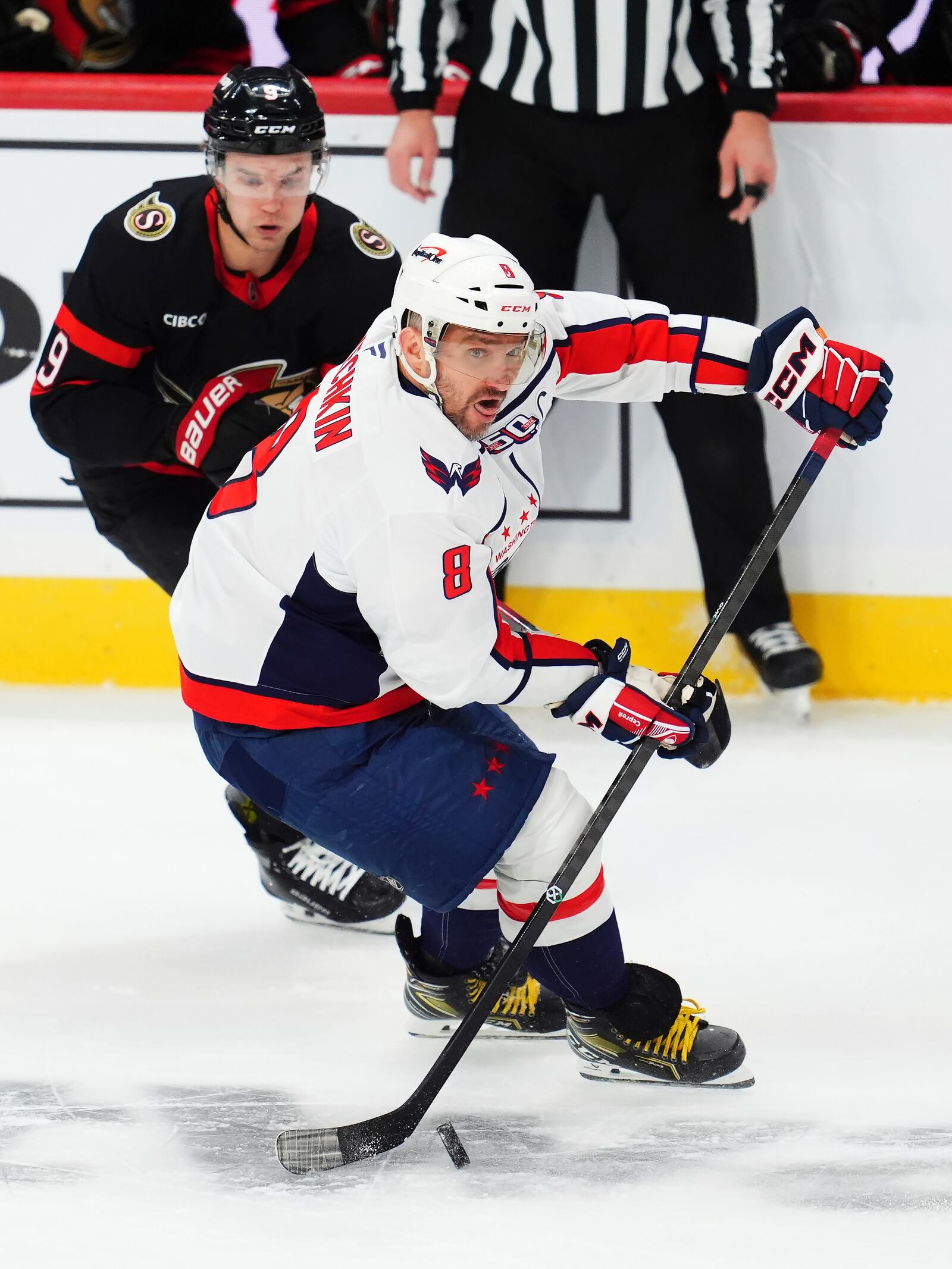 Washington Capitals' Alex Ovechkin (8) protects the puck from Ottawa Senators' Josh Norris (9) during second period of an NHL hockey match in Ottawa, Ontario, Thursday, Jan. 16, 2025. (Sean Kilpatrick/The Canadian Press via AP)