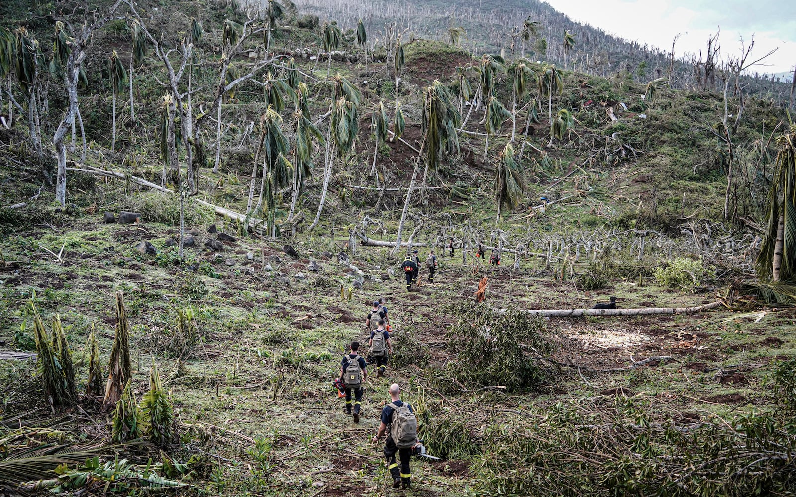 This photo provided by the French Interior Ministry shows rescue workers walking in a devastated area of the French territory of Mayotte in the Indian Ocean, after the island was battered by its worst cyclone in nearly a century, Tuesday Dec. 17, 2024. (Ministere de l'Interieur/Securite Civile via AP)