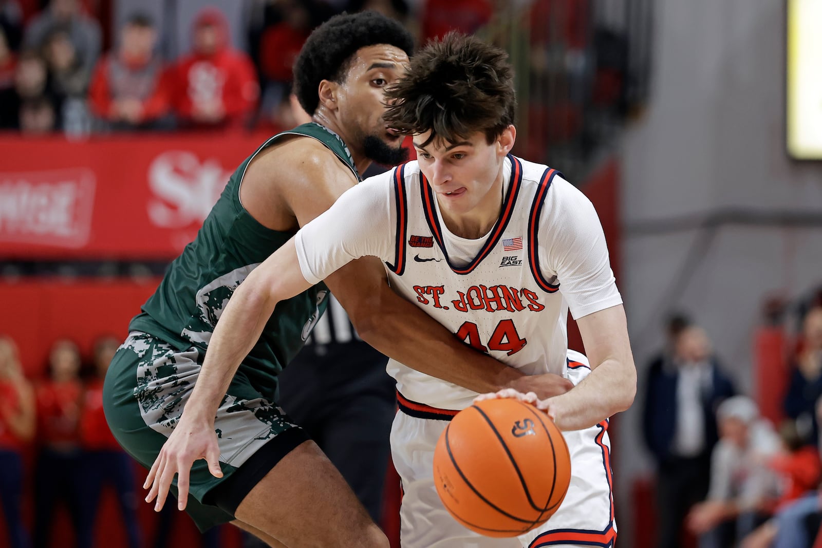 St. John's forward Brady Dunlap (44) drives past Wagner guard Ja'Kair Sanchez during the second half of an NCAA college basketball game Wednesday, Nov. 13, 2024, in New York. St. John's won 66-45. (AP Photo/Adam Hunger)