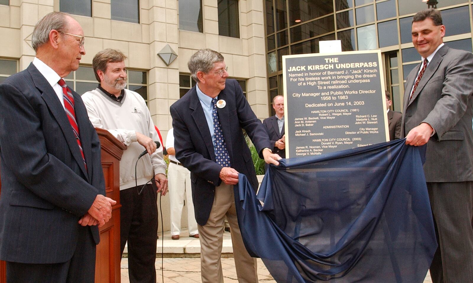 Jack Kirsch and Mayor Don Ryan watch as former vice-mayor Jim Beckett and John Kirsch unviel a plaque for the underpass during a ceremony at the GSC Saturday, 6/14/03. E.L. HUBBARD/JOURNALNEWS