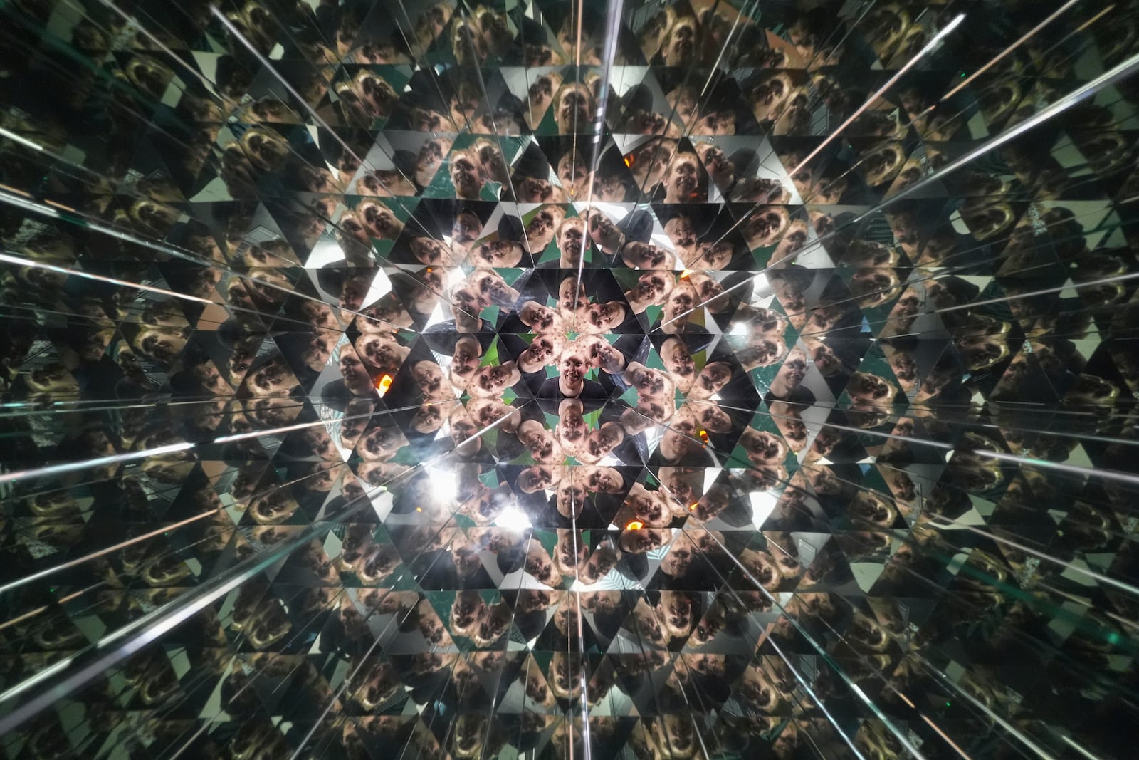 Nathan McDonnell, visiting from New York City, looks into a kaleidoscope at Paradox Museum Miami, Tuesday, Jan. 28, 2025, in Miami. (AP Photo/Rebecca Blackwell)