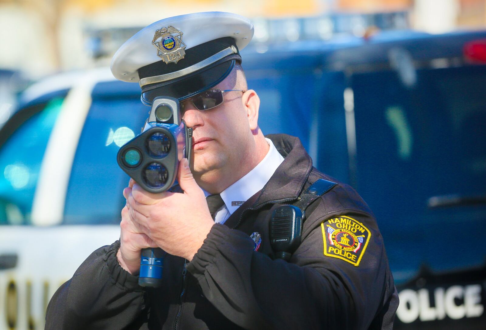 Hamilton police department traffic officer Michael Coleman demonstrates one of their new Laser Technologies LTI20/20 Trucam hand held laser speed measuring devices, Monday, Feb. 13, 2017. The new devices can record video and still photographs. GREG LYNCH / STAFF