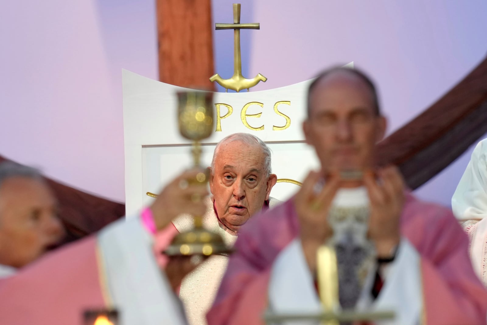 Pope Francis celebrates a mass Sunday, Dec. 15, 2024 in Ajaccio, Corsica island, as his one-day visit to Corsica puts a dual focus on the Mediterranean, highlighting local traditions of popular piety on the one hand and migrant deaths and wars on the other. (AP Photo/Thibault Camus)