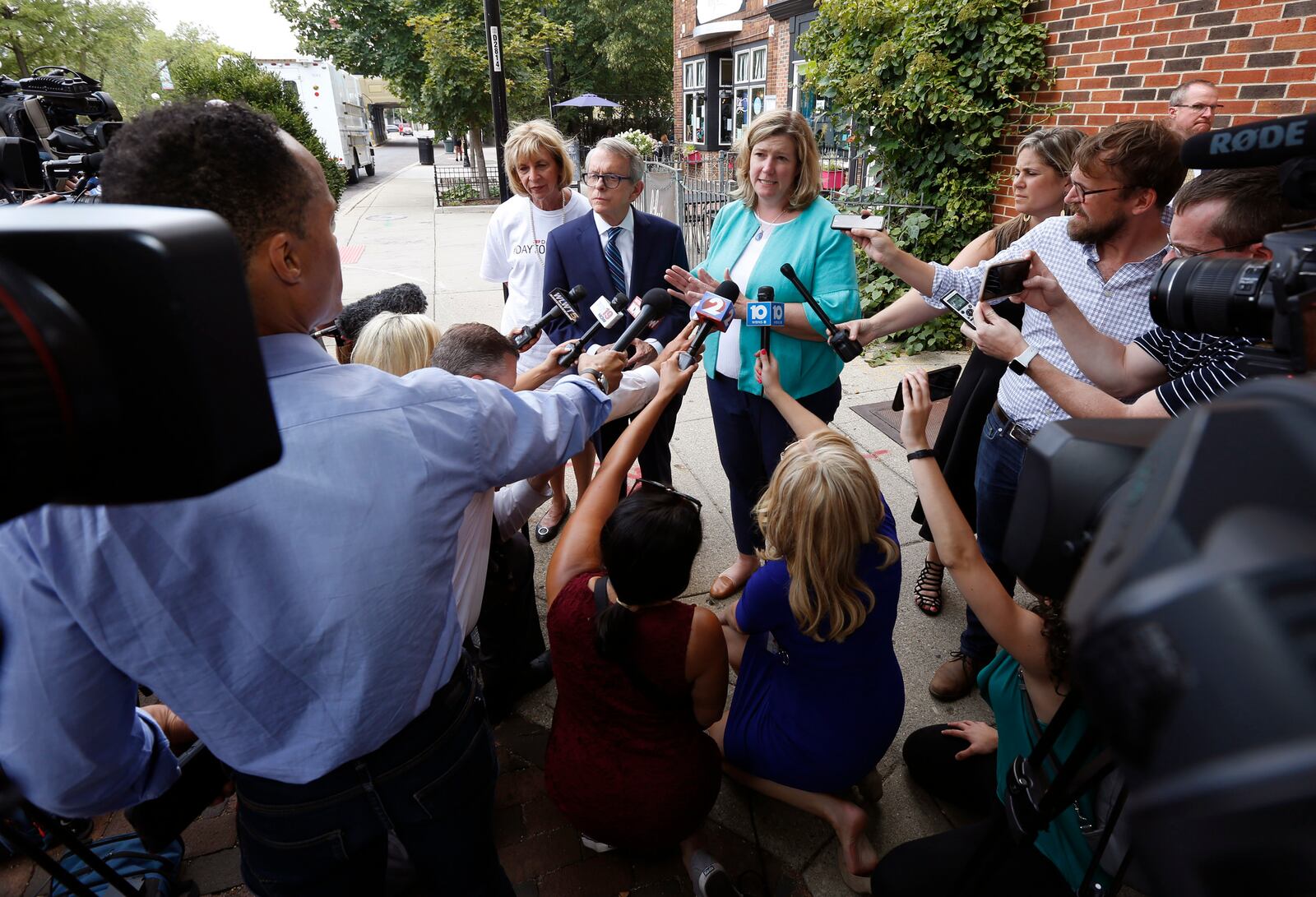 Ohio Governor Mike Dewine and Dayton Mayor Nan Whaley are among Ohio politicians seeking gun legislation that addresses more than mass shooting threats. Here the two spoke Aug. 8 in the Oregon District. TY GREENLEES / STAFF