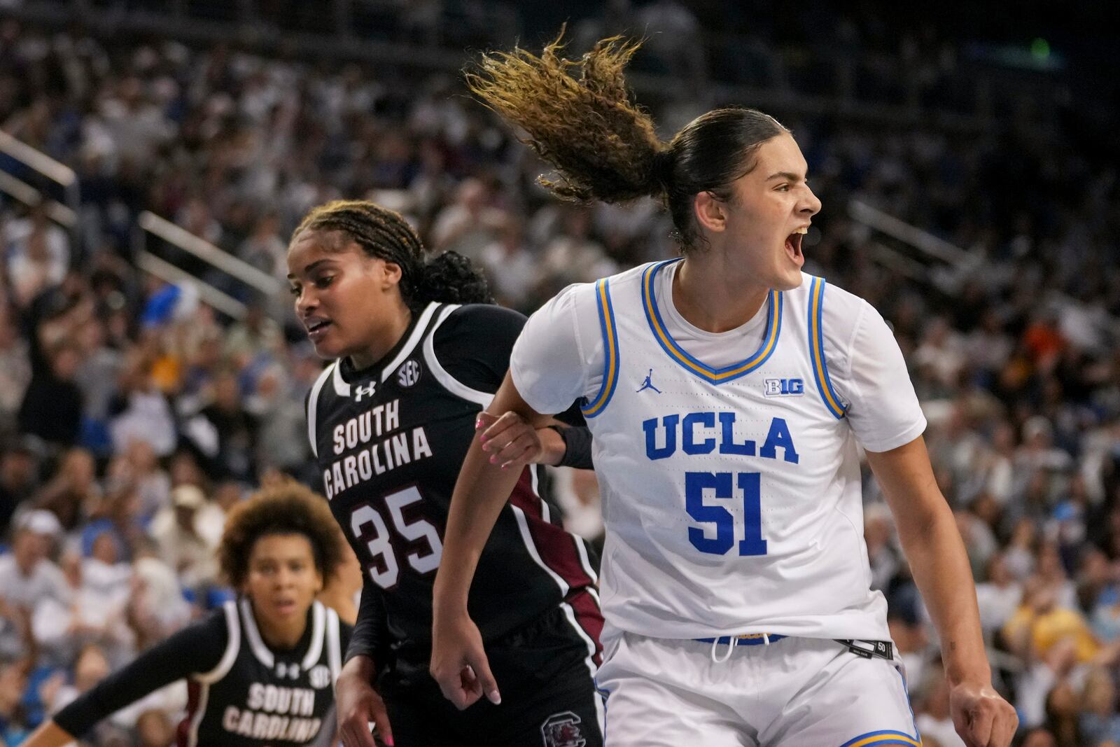 UCLA center Lauren Betts (51) reacts next to South Carolina center Sakima Walker (35) during the second half of an NCAA college basketball game Sunday, Nov. 24, 2024, in Los Angeles. (AP Photo/Eric Thayer)