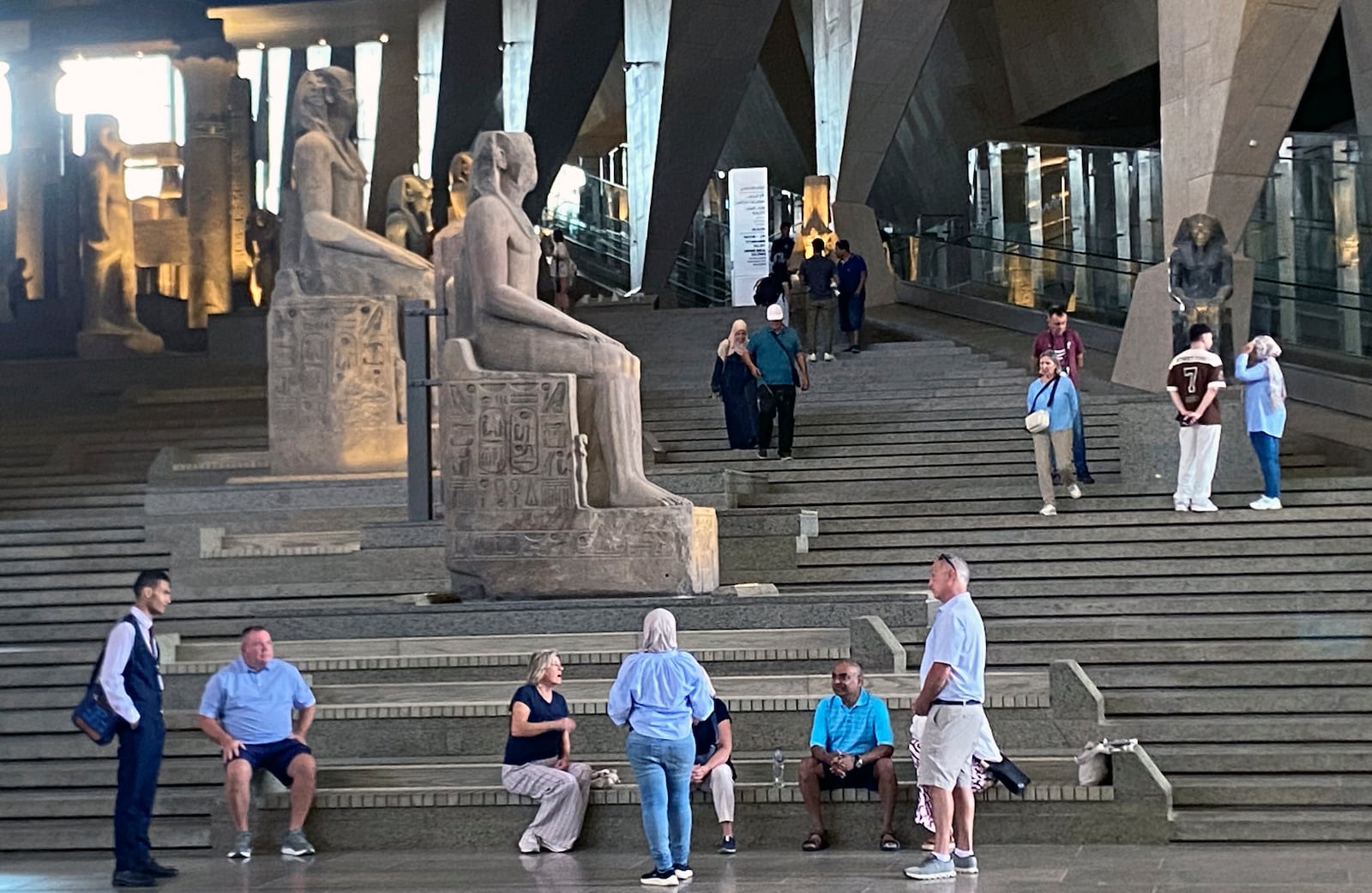 Visitors walk past ancient Egyptian colossal statues along the Grand Staircase at the Grand Egyptian Museum in Giza, Egypt, Tuesday, Oct.15, 2024. (AP Photo/Khaled Elfiqi)